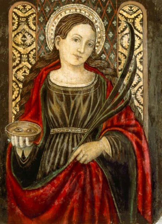 Why does St. Lucy hold a set of eyeballs in her hand?