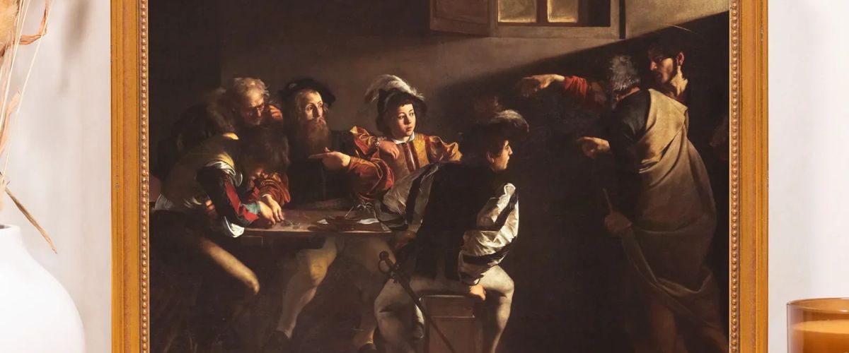 Framed painting of a biblical scene with figures gathered around a table in dramatic lighting