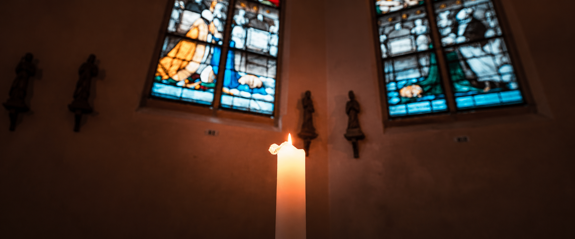 Who was the saint who lit a candle with his fingertips?