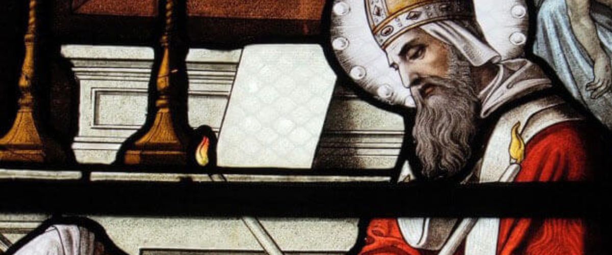 A stained glass window depicting Saint Blaise in ceremonial robes, speaking to a woman and a child, capturing a gentle moment of interaction with expressive faces and detailed attire.