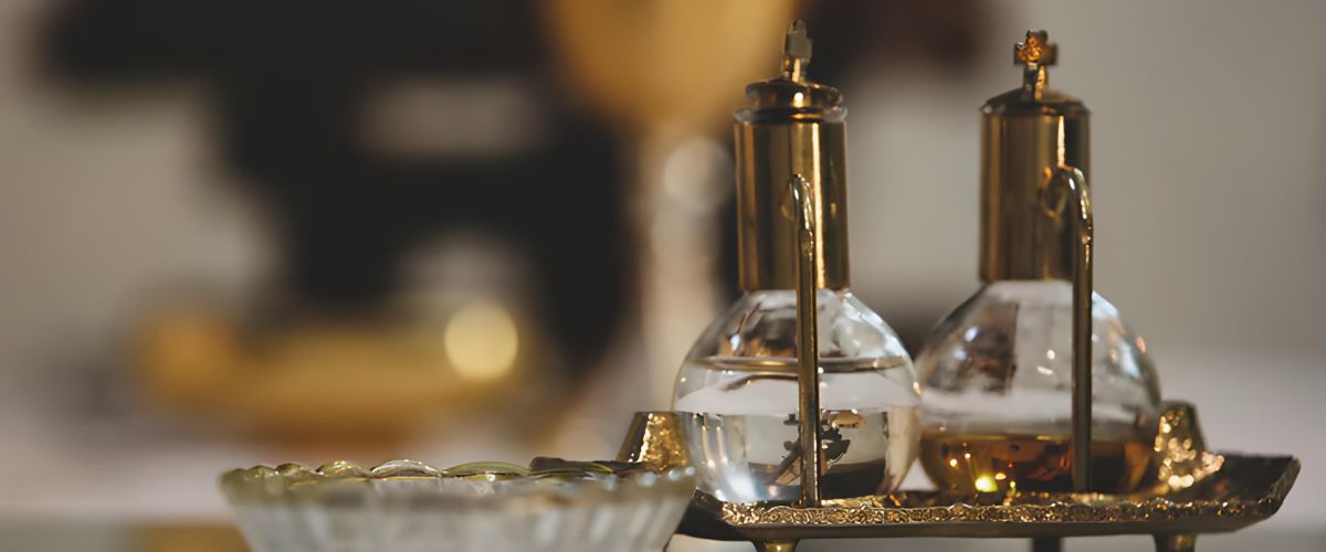 Glass cruets with oil on a gold tray, used for religious anointing