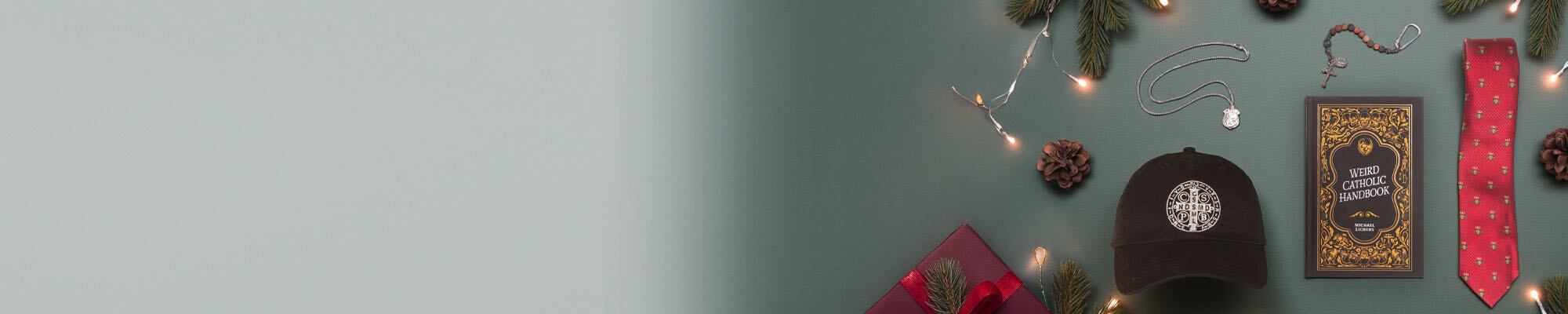 A black hat, The Weird Catholic Handbook, a red tie and some Catholic Jewelry on a festive green background