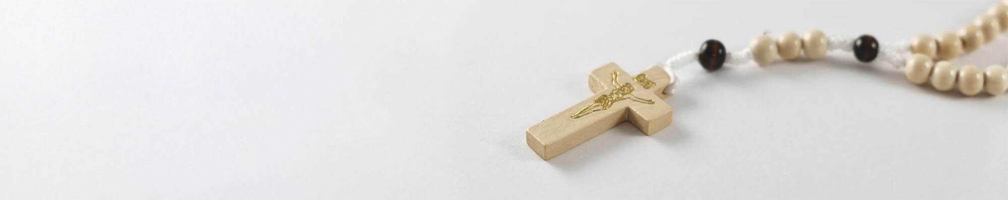 Catholic rosary on white backdrop