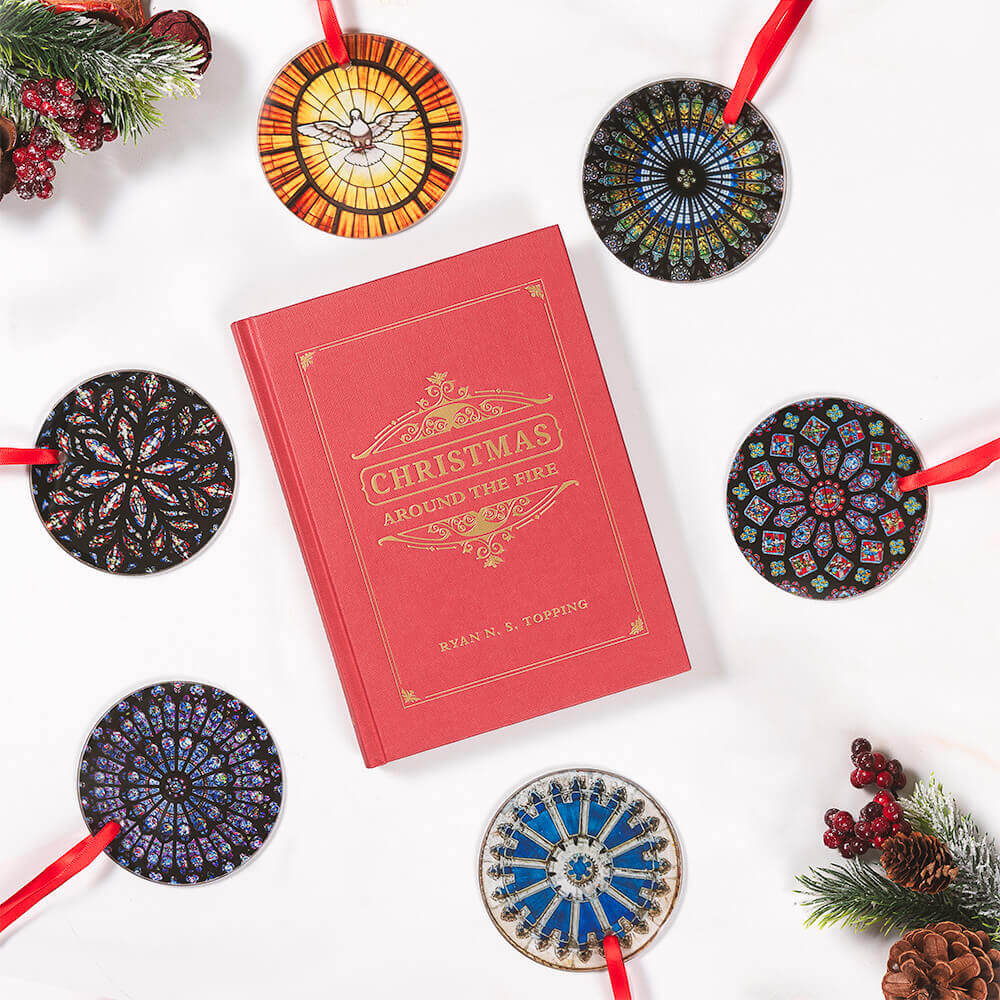 Red book titled 'Christmas Around the Fires' with decorative Christmas ornaments on a white background