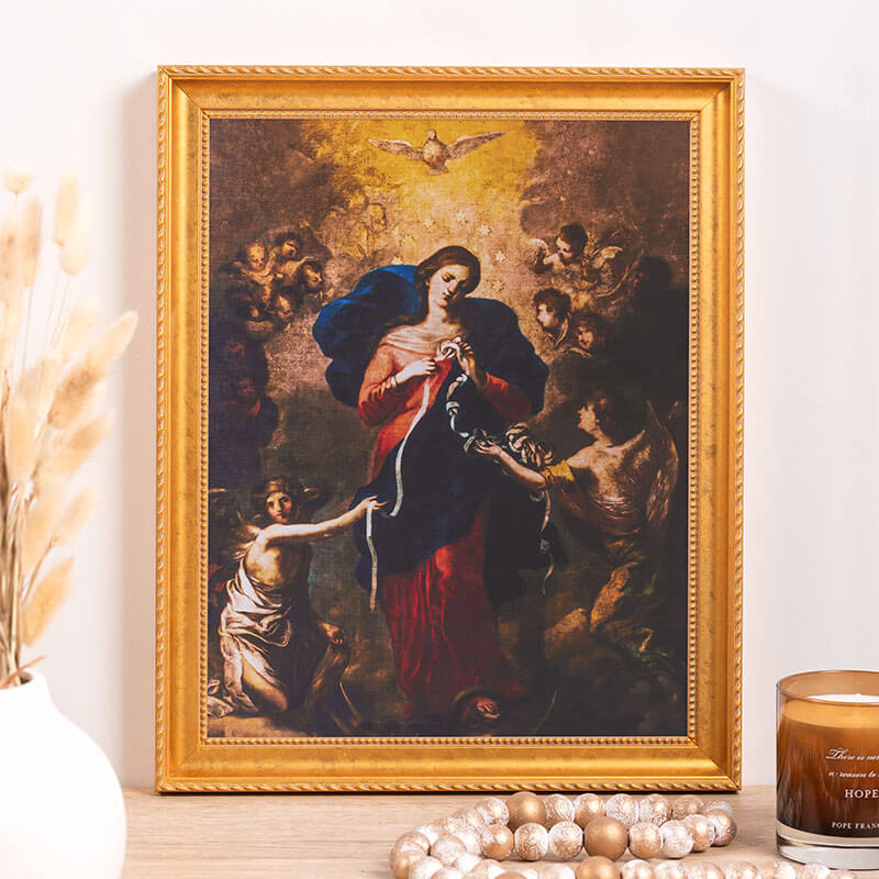 Framed religious painting on a wall with decorative elements.
