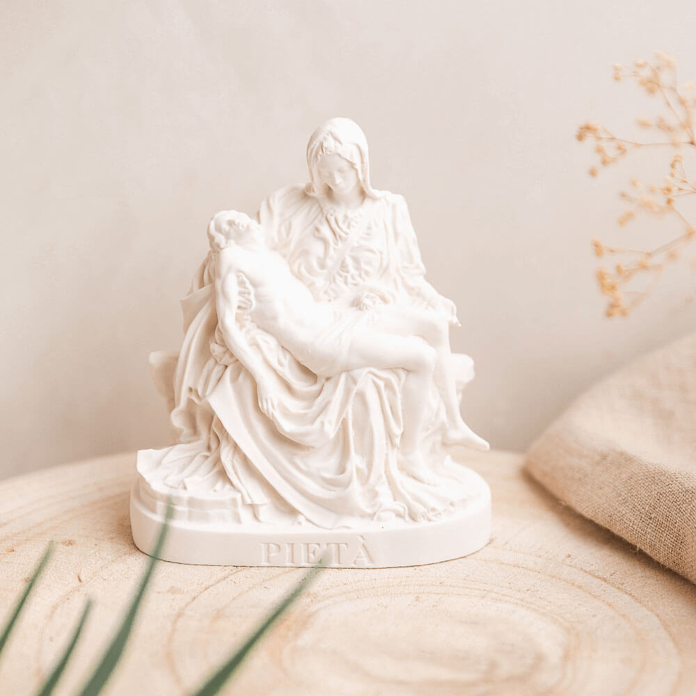 White Pieta statue on a neutral background
