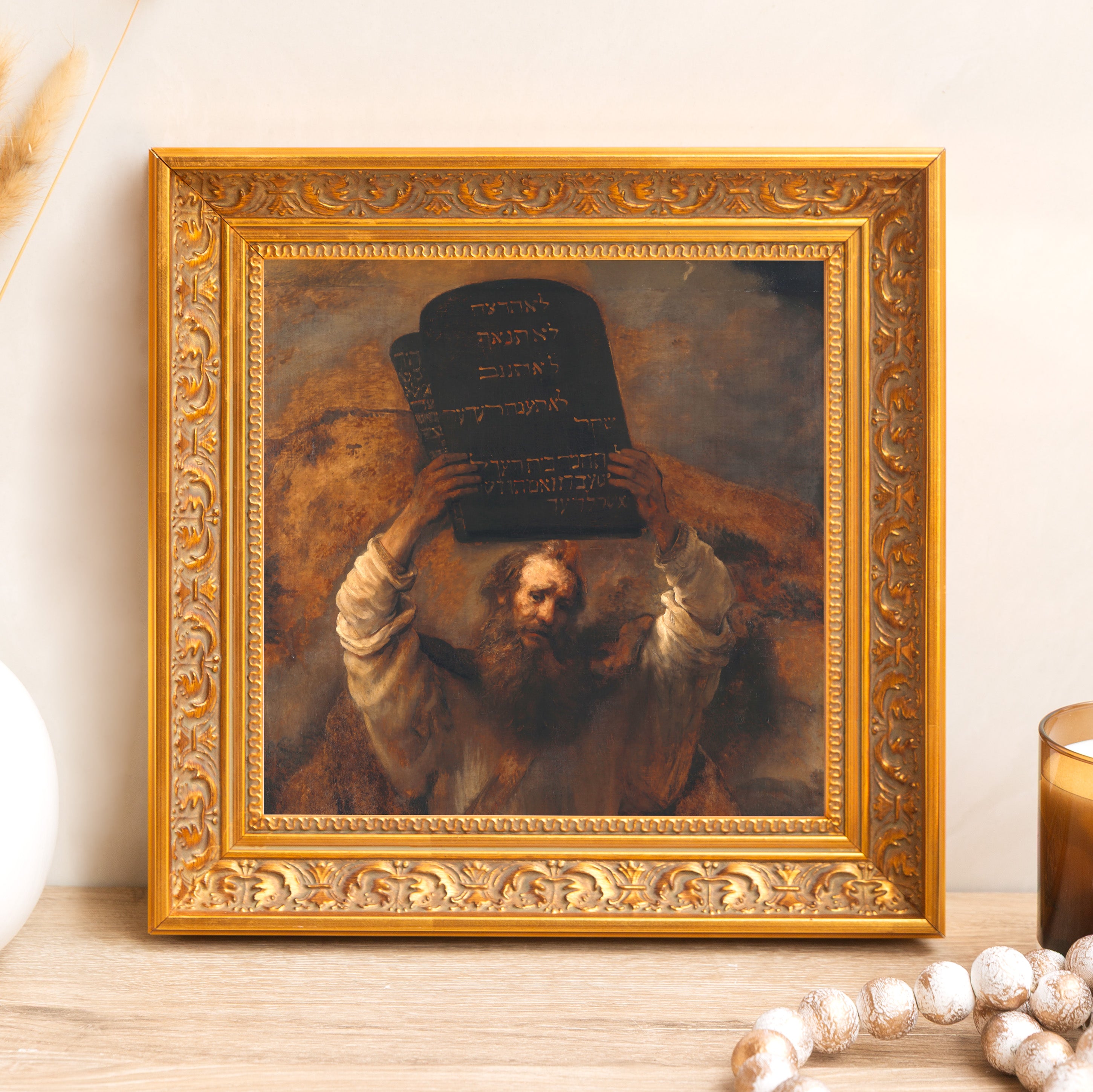 Framed print. Classic art depicting Moses holding the tablets in an ornate, gold frame.