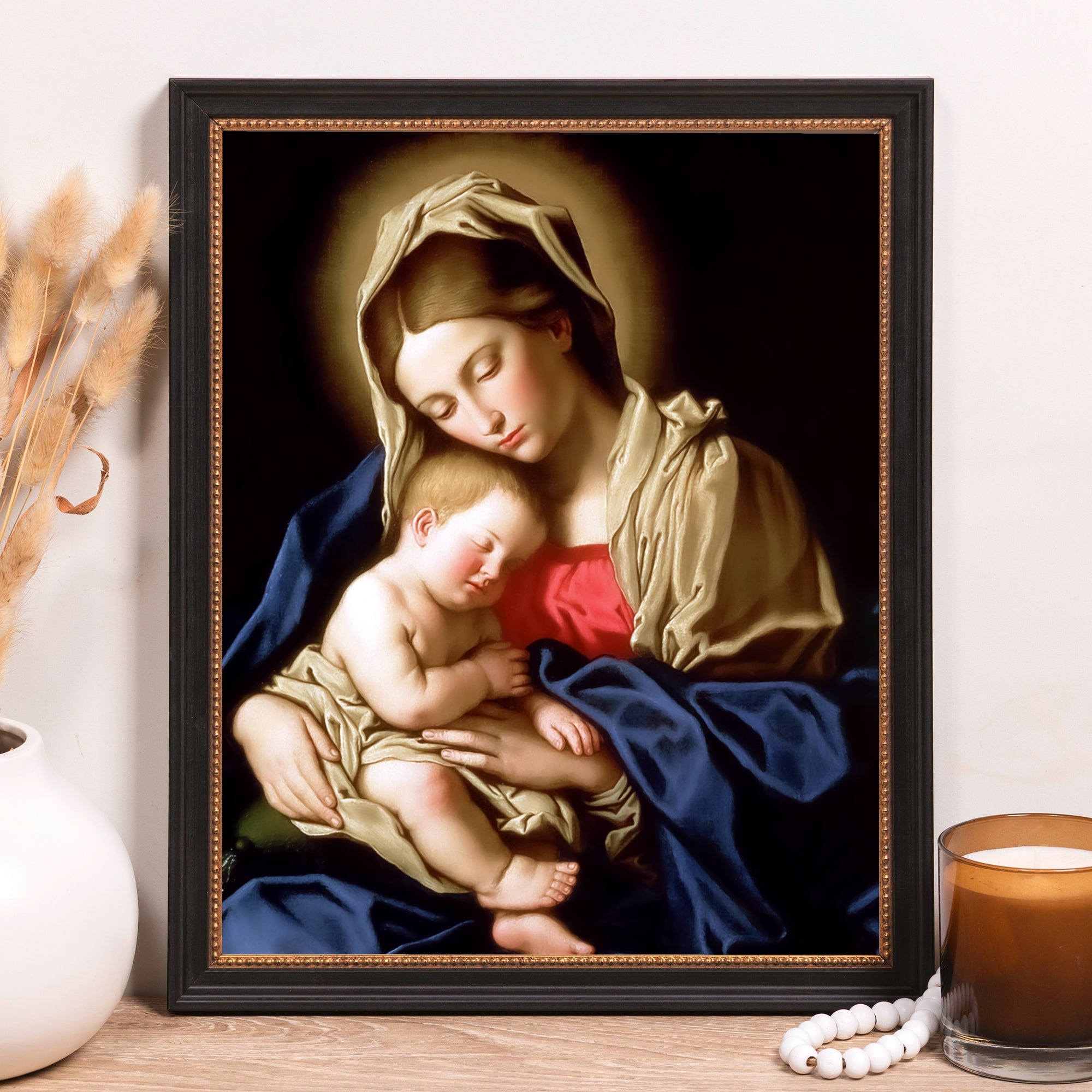 Framed oil painting of Madonna and Child, showing draped figures in rich blues and golds.