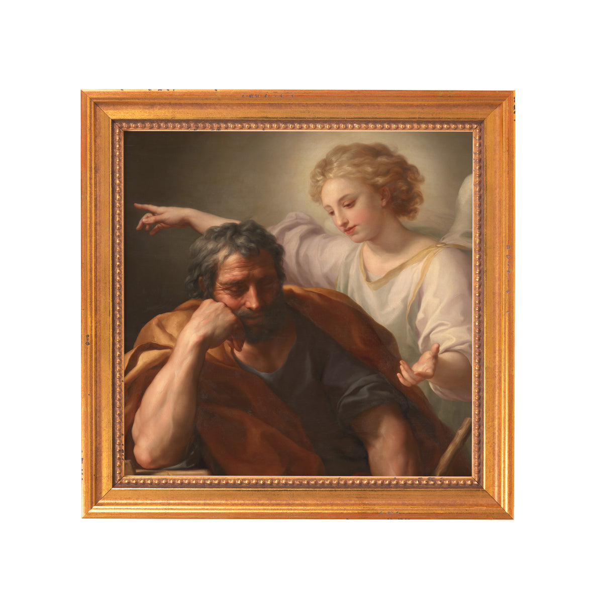 Framed oil painting of Joseph's dream, in a gold-colored frame, with the man in brown robe and an angel in white gown beside him.