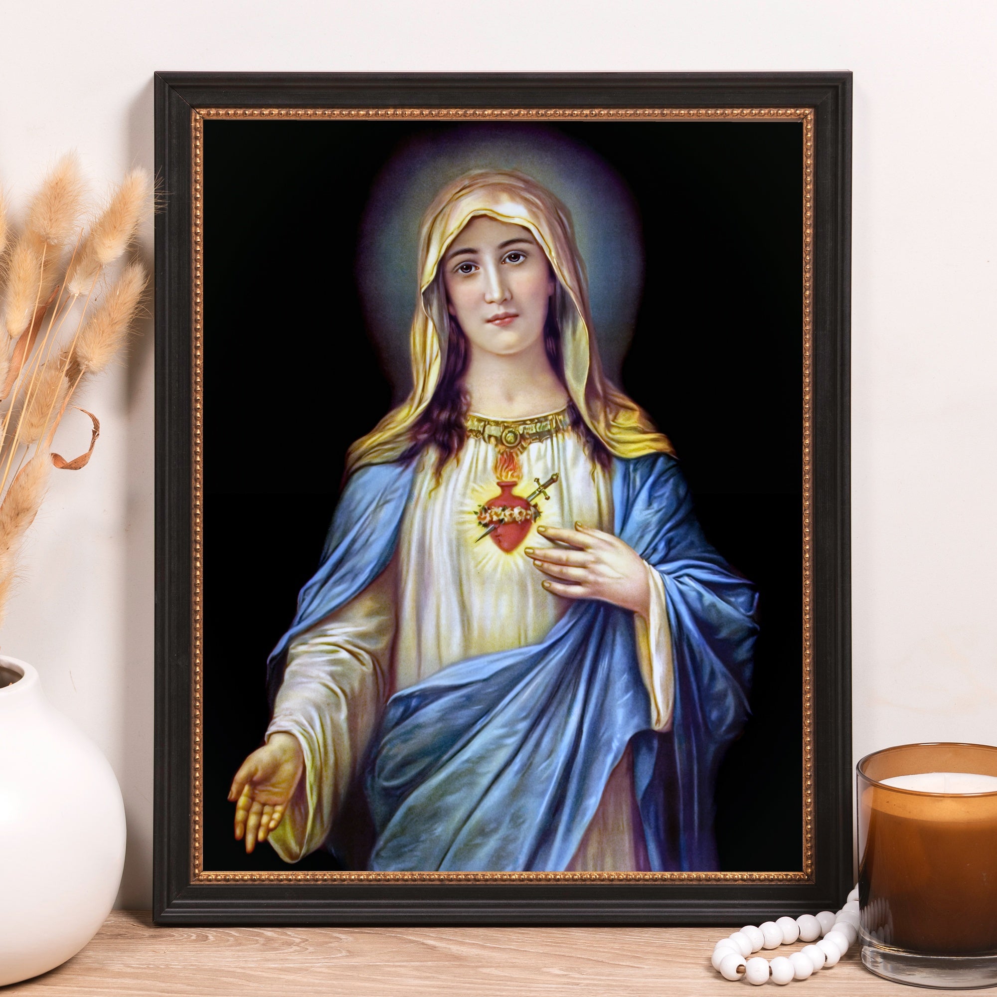 Framed Virgin Mary print with blue and white robes on black background.