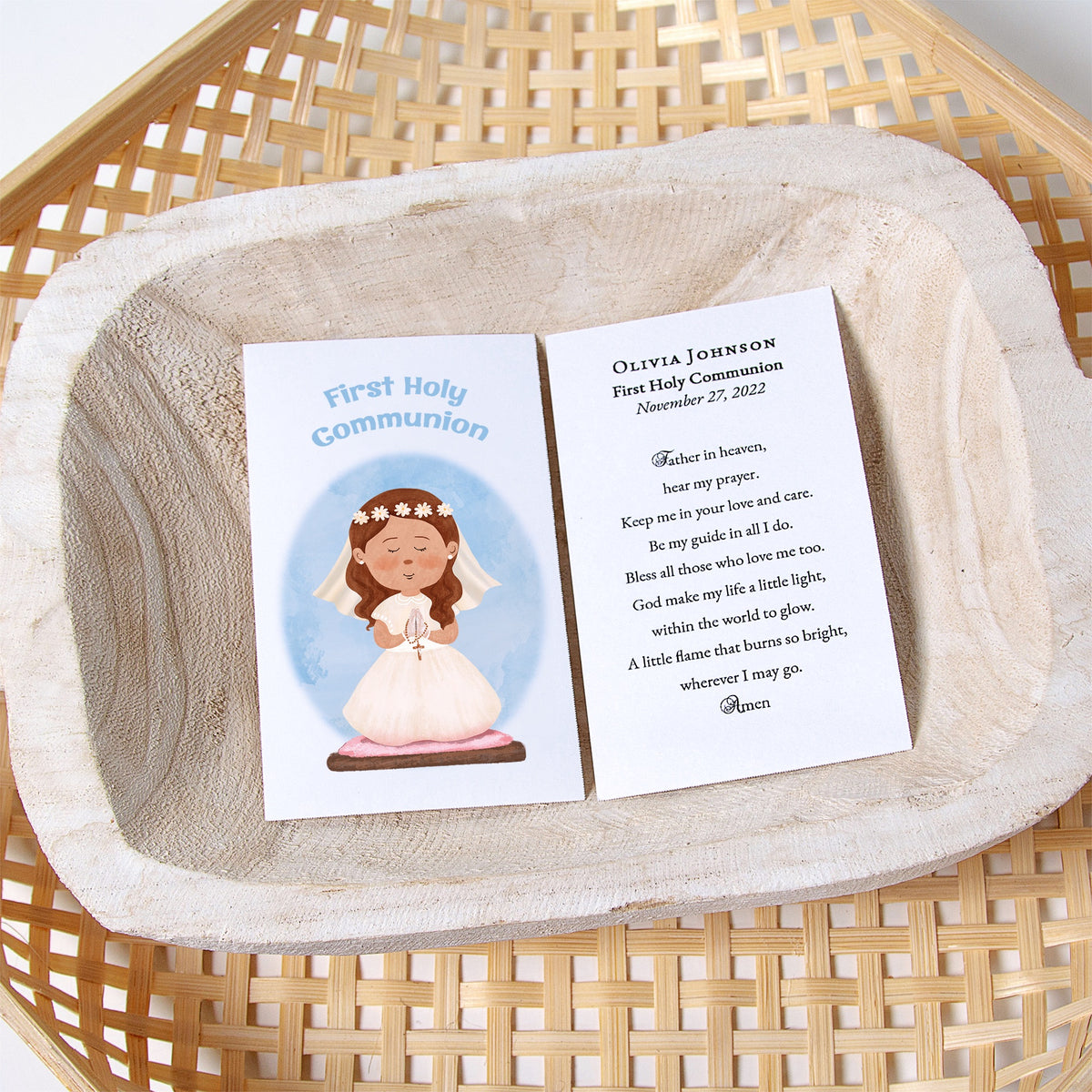 First Holy Communion prayer card with girl illustration in a wicker bowl.
