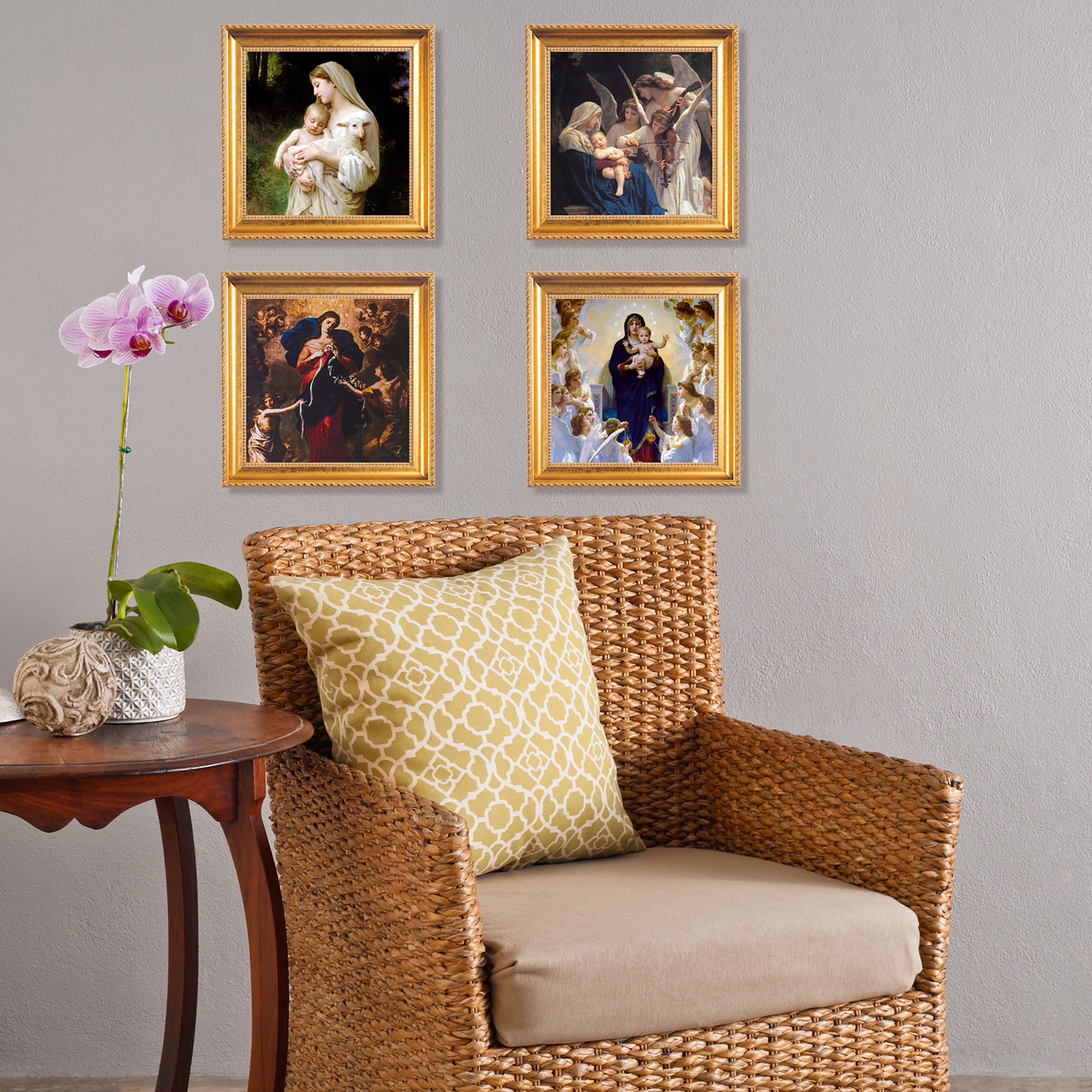 Framed religious art with gold frames hanging above a brown wicker chair.