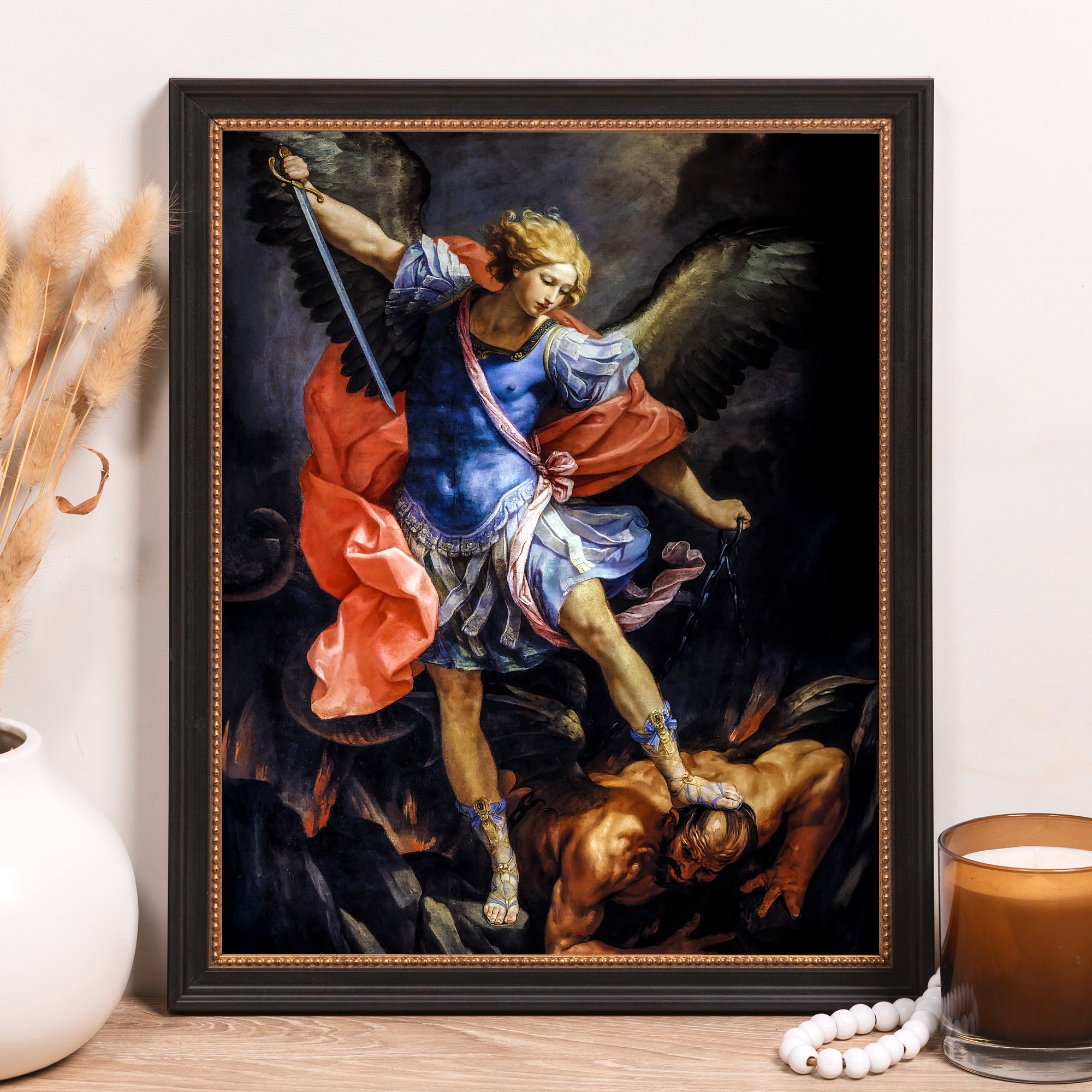 Framed Print of Michael overcoming Satan, painted canvas art in black frame.