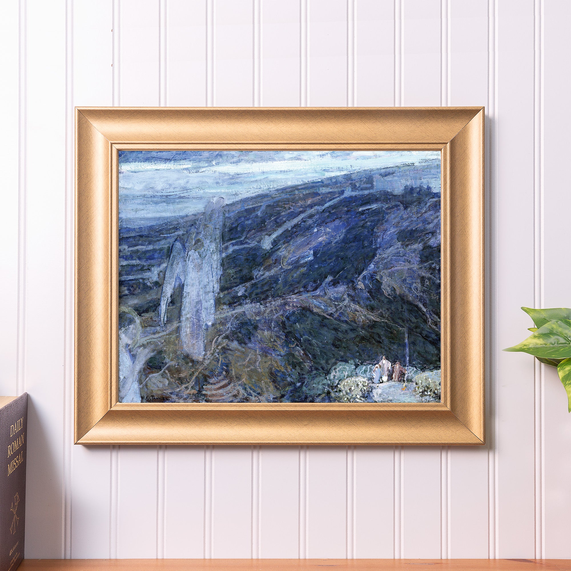 Framed landscape painting with gold frame, dark blues and whites used in the impressionistic art style.