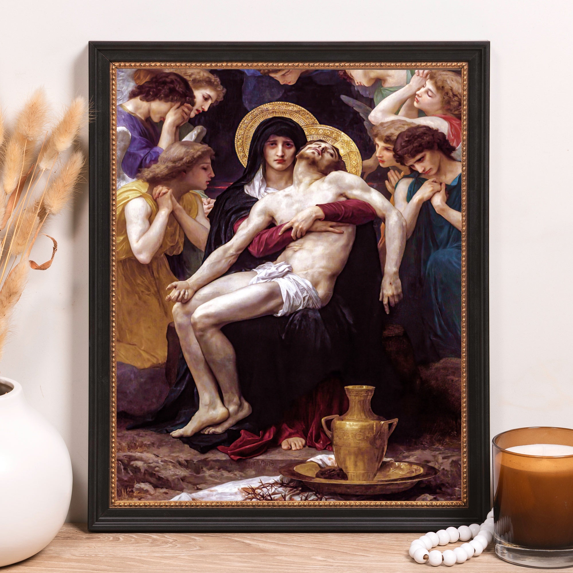 Framed "Pieta" print shows Mary holding Jesus surrounded by angels, painted in Renaissance style.