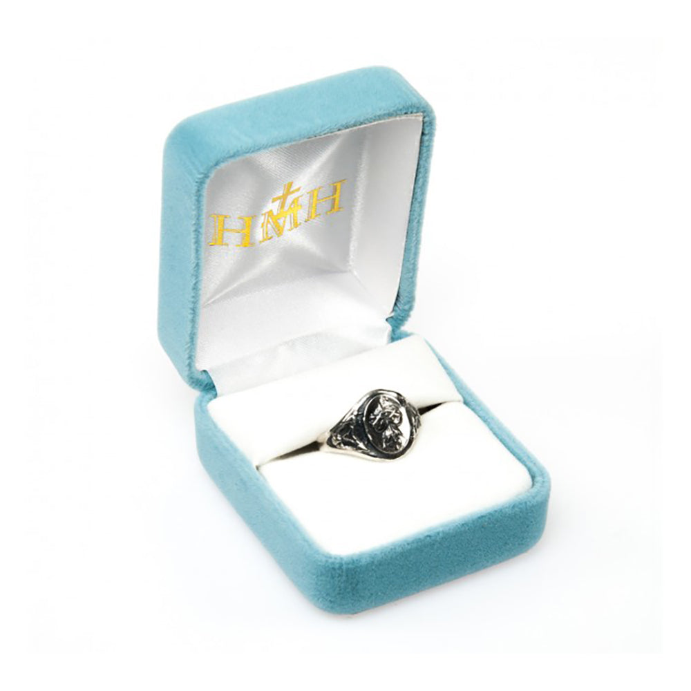 Silver signet ring in light blue velvet box with white lining for presentation purposes.