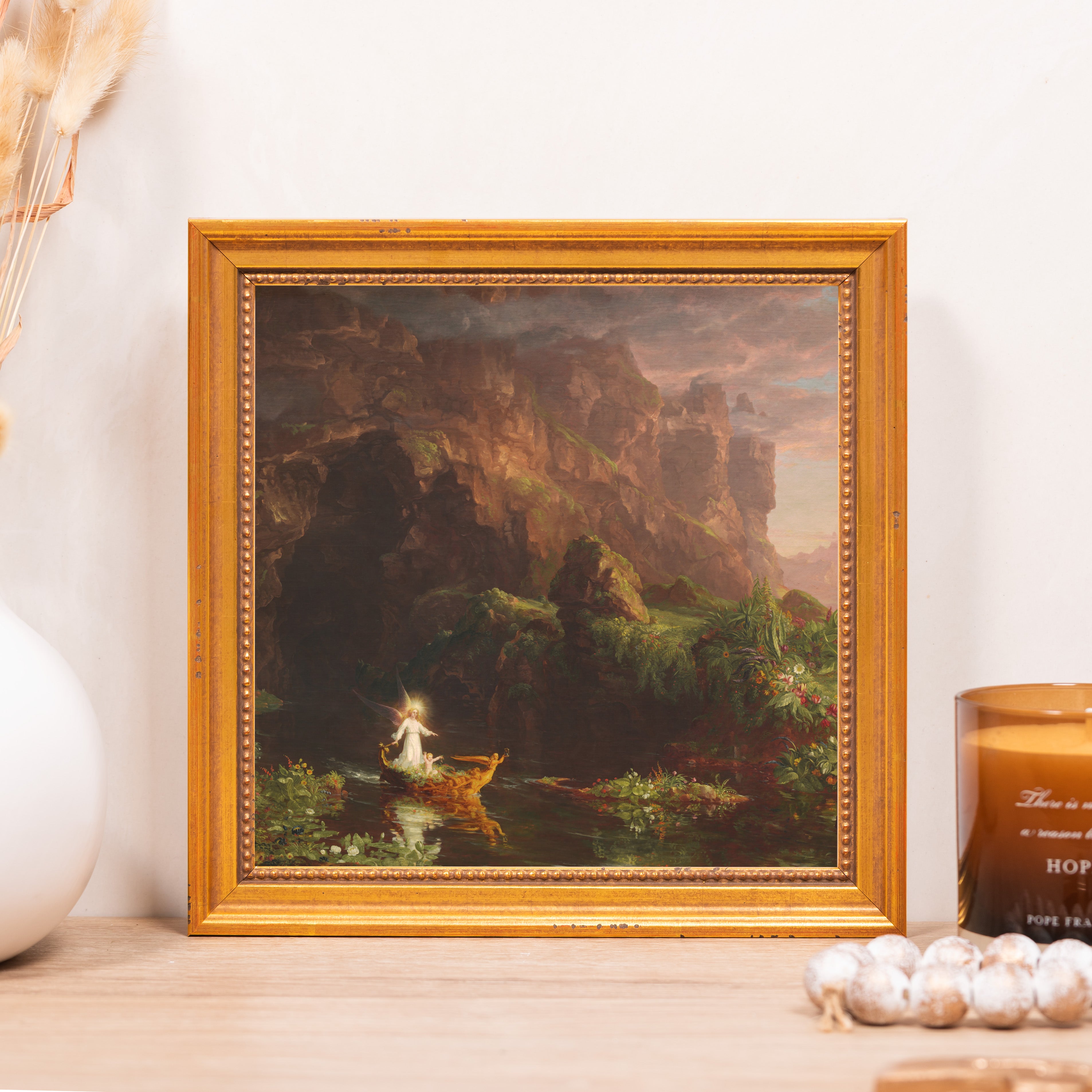 Framed painting depicts angel on water, displayed as home decor in a gold frame.