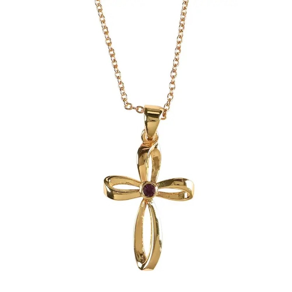 Gold cross necklace with a curved ribbon design and a small red gemstone in the center.