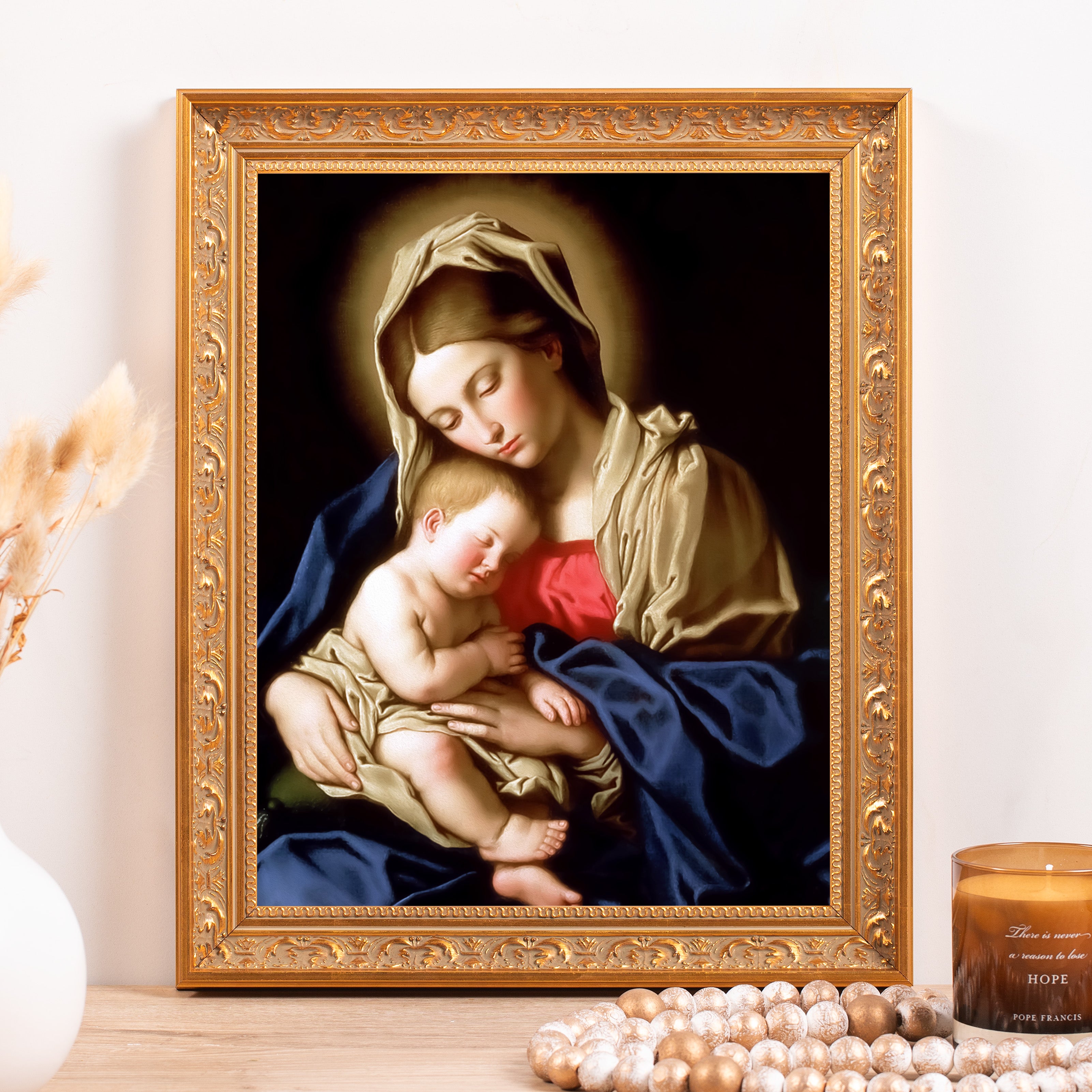Framed Painting of Mary and baby Jesus with blue and gold coloring and ornate gold frame for religious decor.
