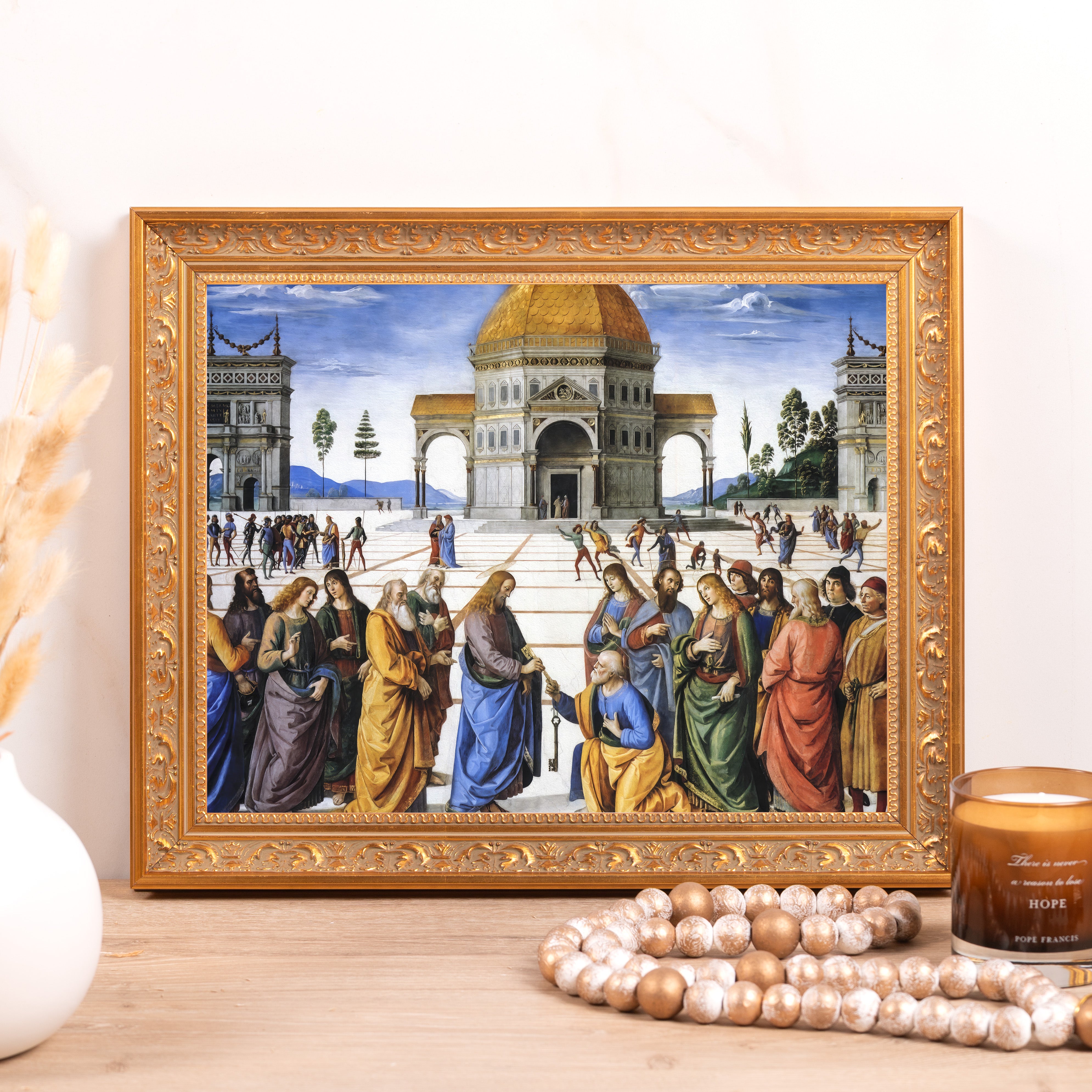 Framed print of religious scene in ornate gold frame.