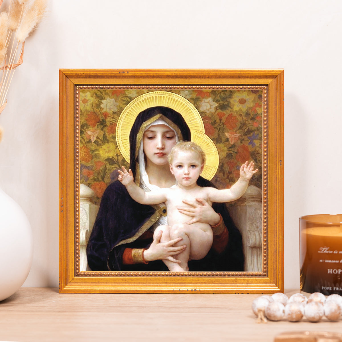 Framed print of Mary and baby Jesus with gold halos in a gold frame; religious decor.