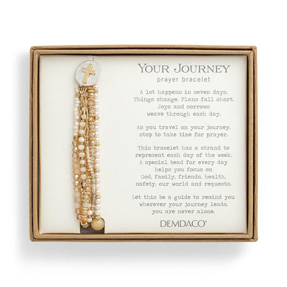 Boxed beaded prayer bracelet with cross charm; pearl, gold, and tan beads on multiple strands.
