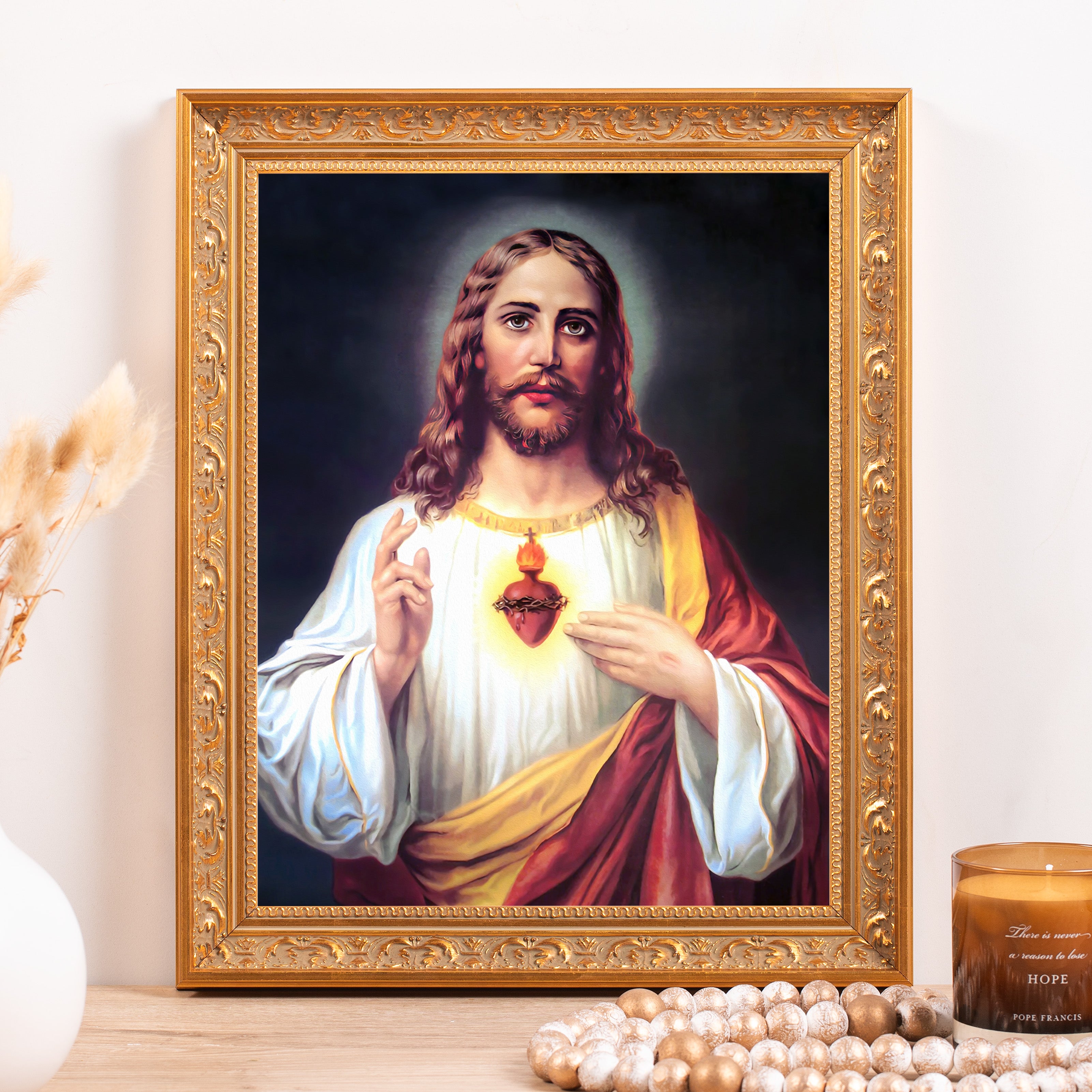 Framed Sacred Heart print with golden ornamental frame, depicting Jesus Christ.