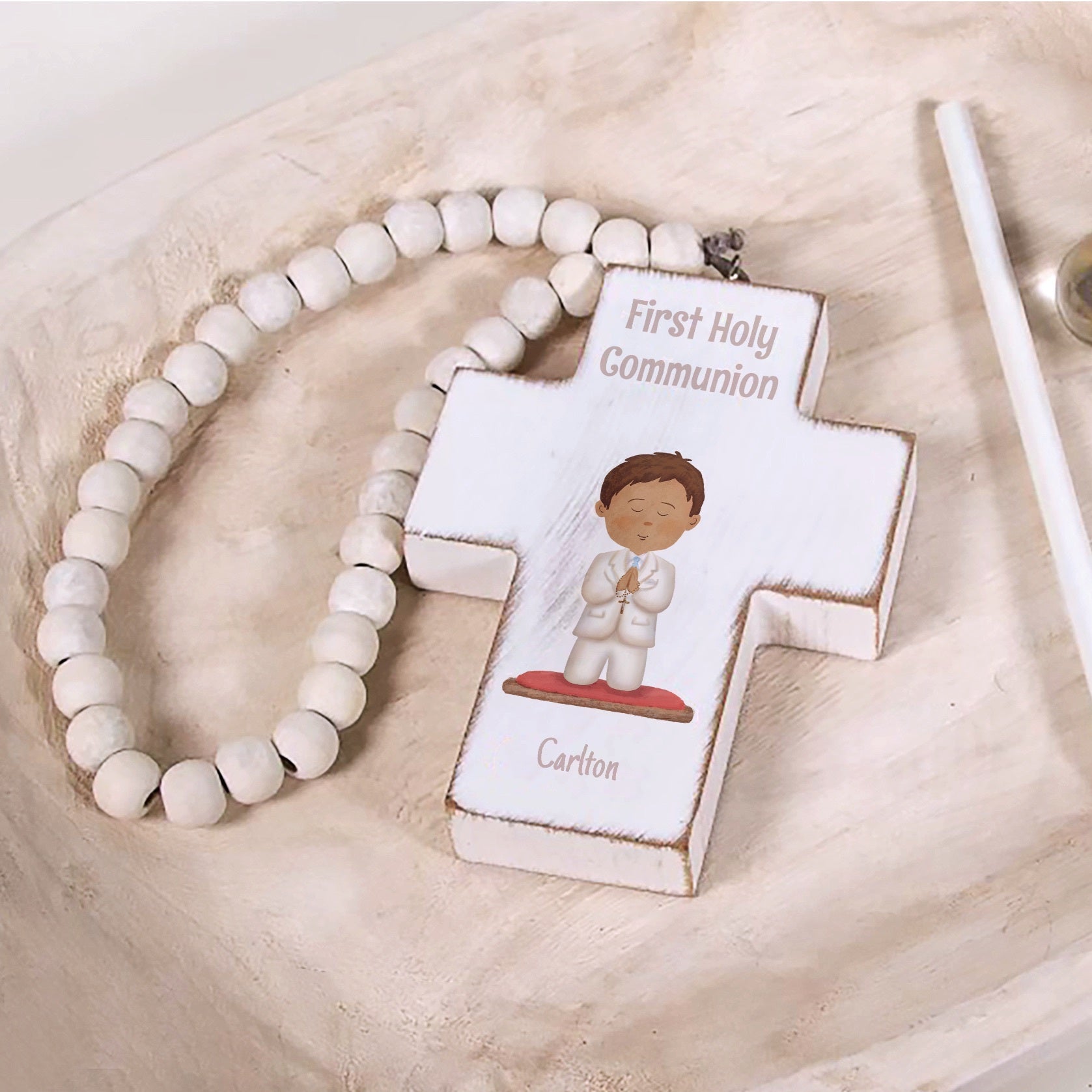 First Holy Communion cross with bead strand; white wood, features cartoon boy image and child's name.