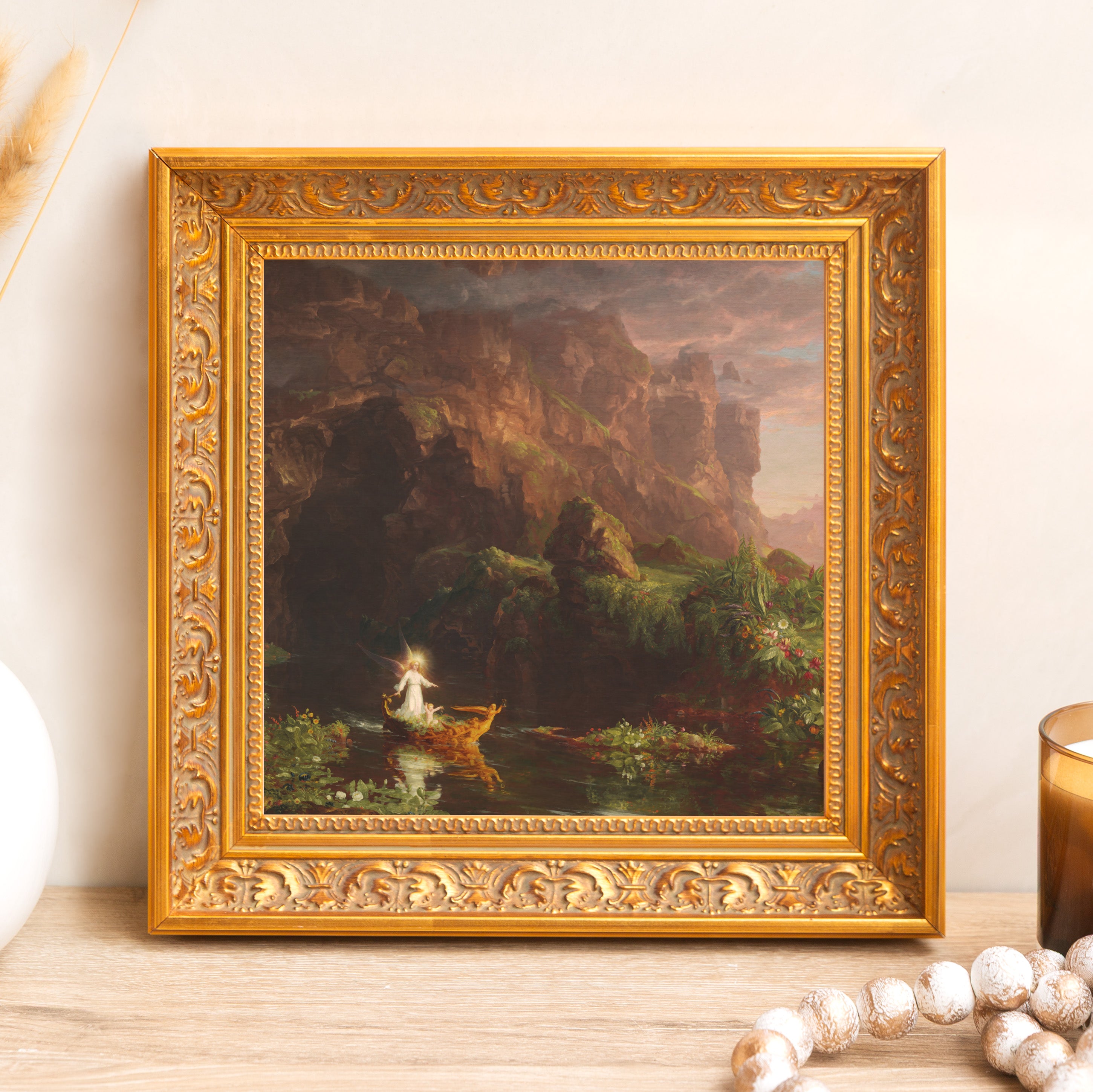 Framed oil painting with gold ornate wood frame depicting an angel on water near rocks.