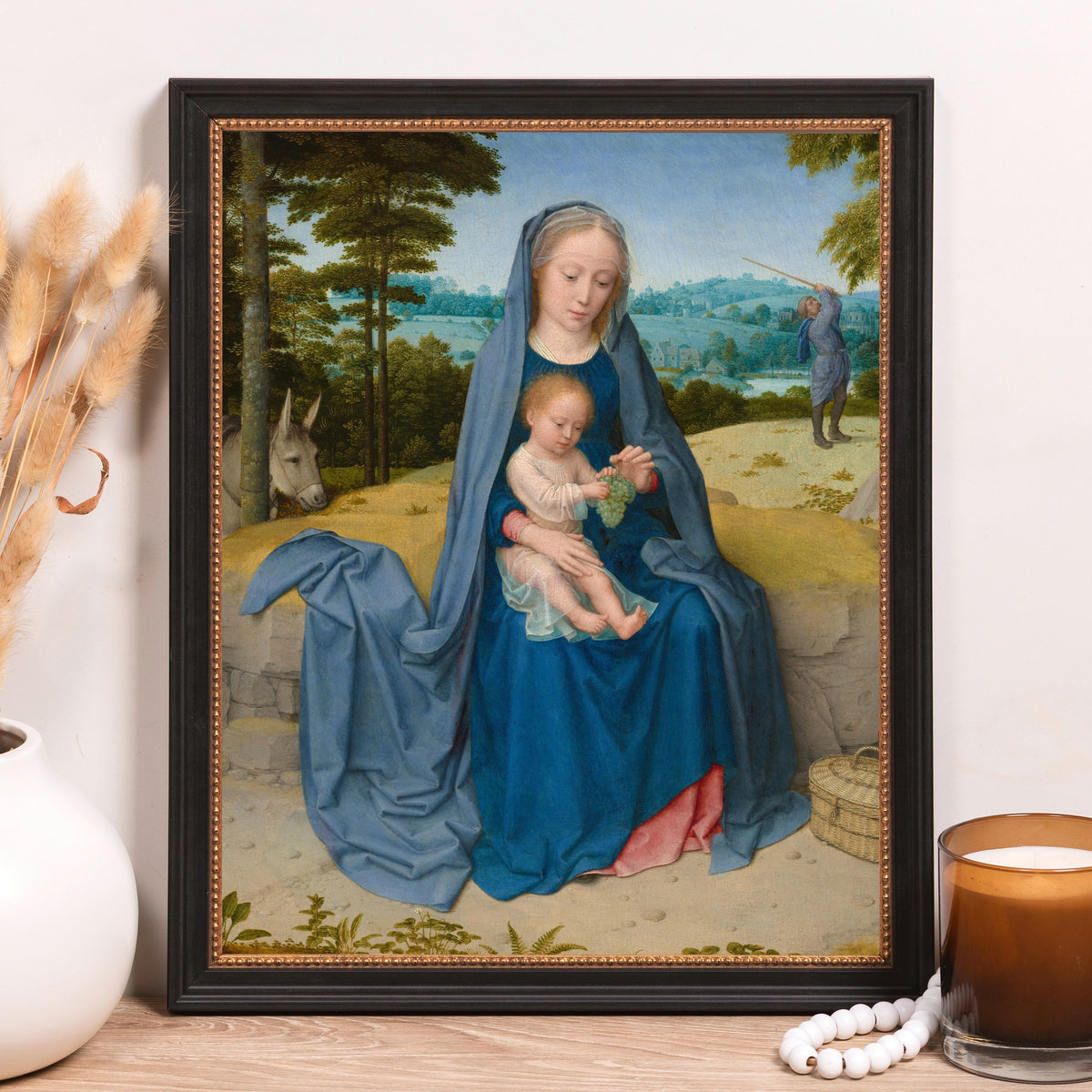 Framed print of Mary and Jesus in blue robes with black frame and gold trim for home decor use.