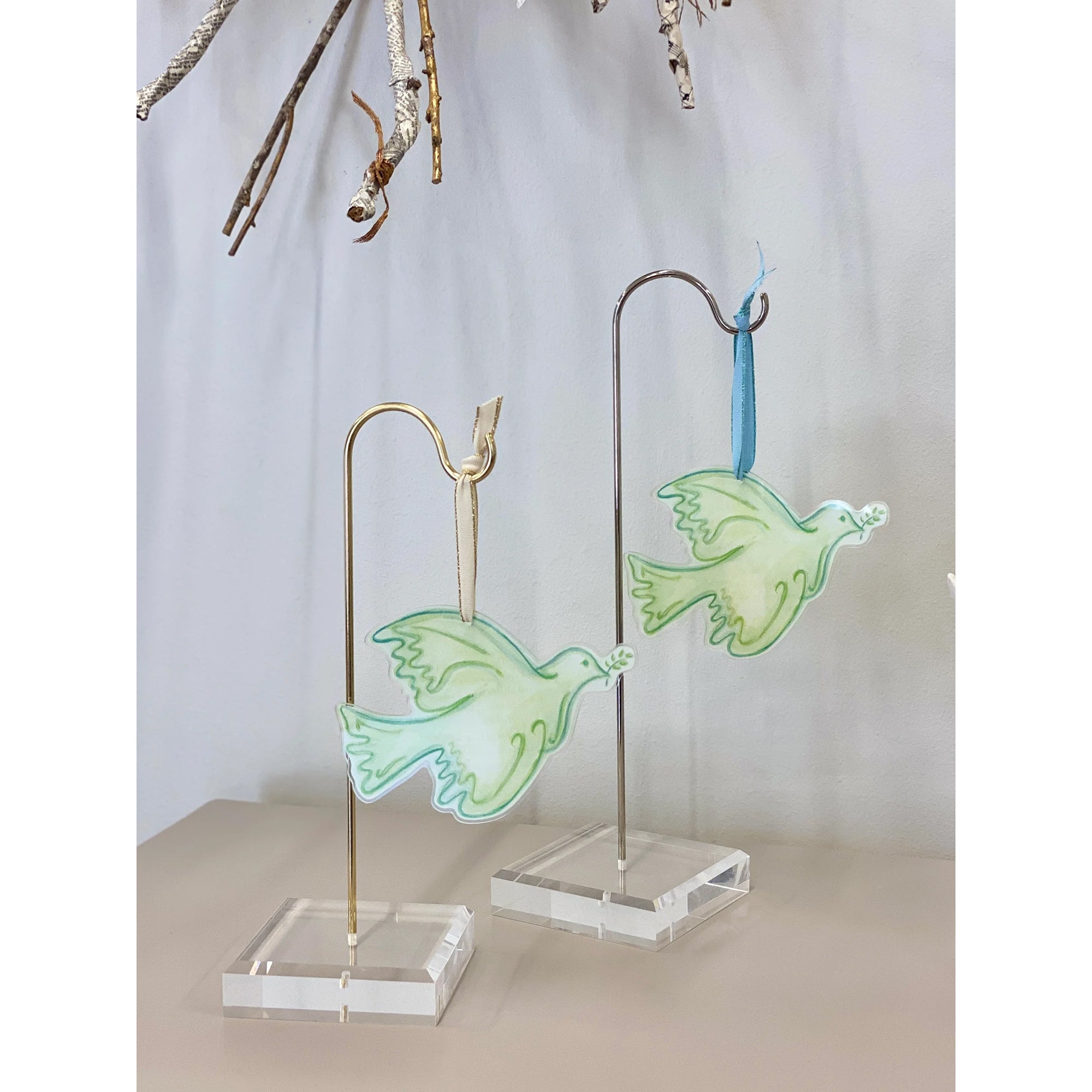 Dove ornaments on stands. Green and white with blue or gold ribbon.