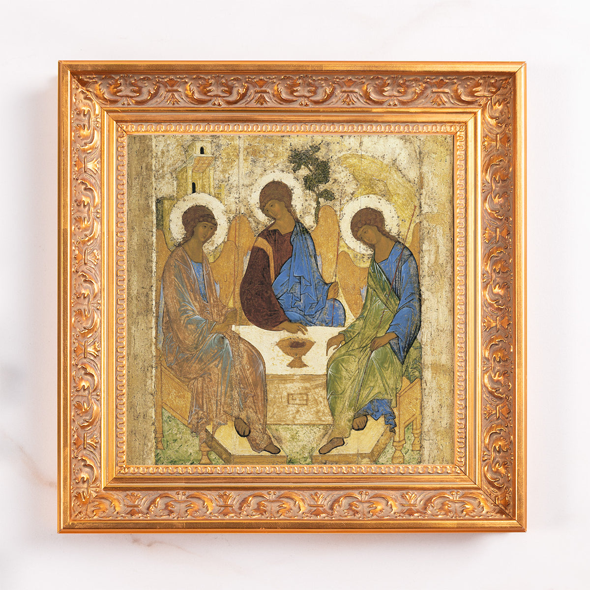 Religious art depicting The Trinity in golden frame.