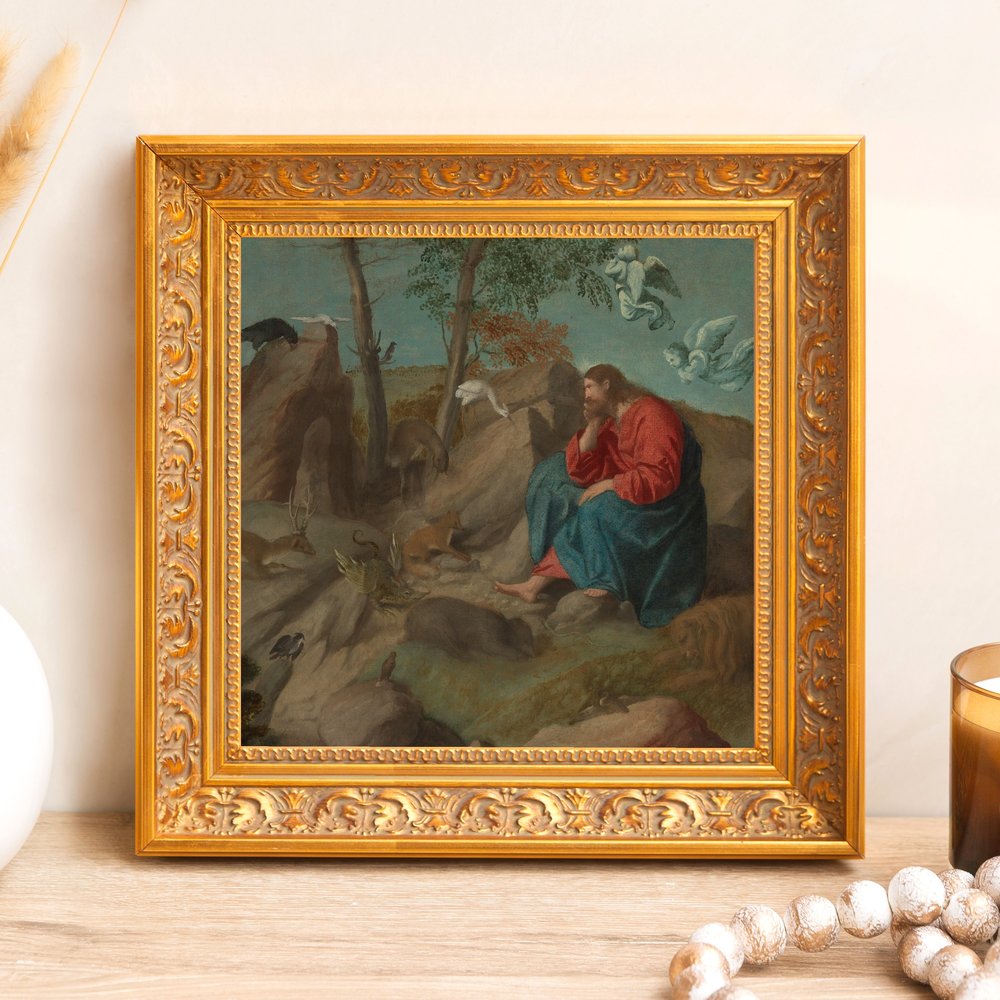 Framed, vintage-style print depicting Jesus meditating in the wilderness; ornate gold frame.