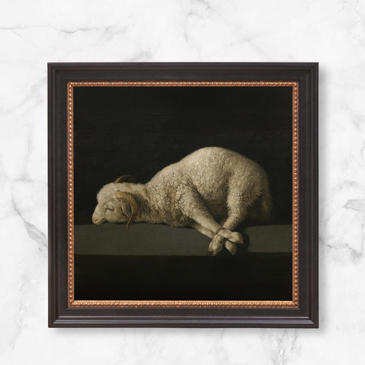 Framed "Agnus Dei" print, vintage style. The painting is of a sheep with dark background, in a dark frame with golden detail.