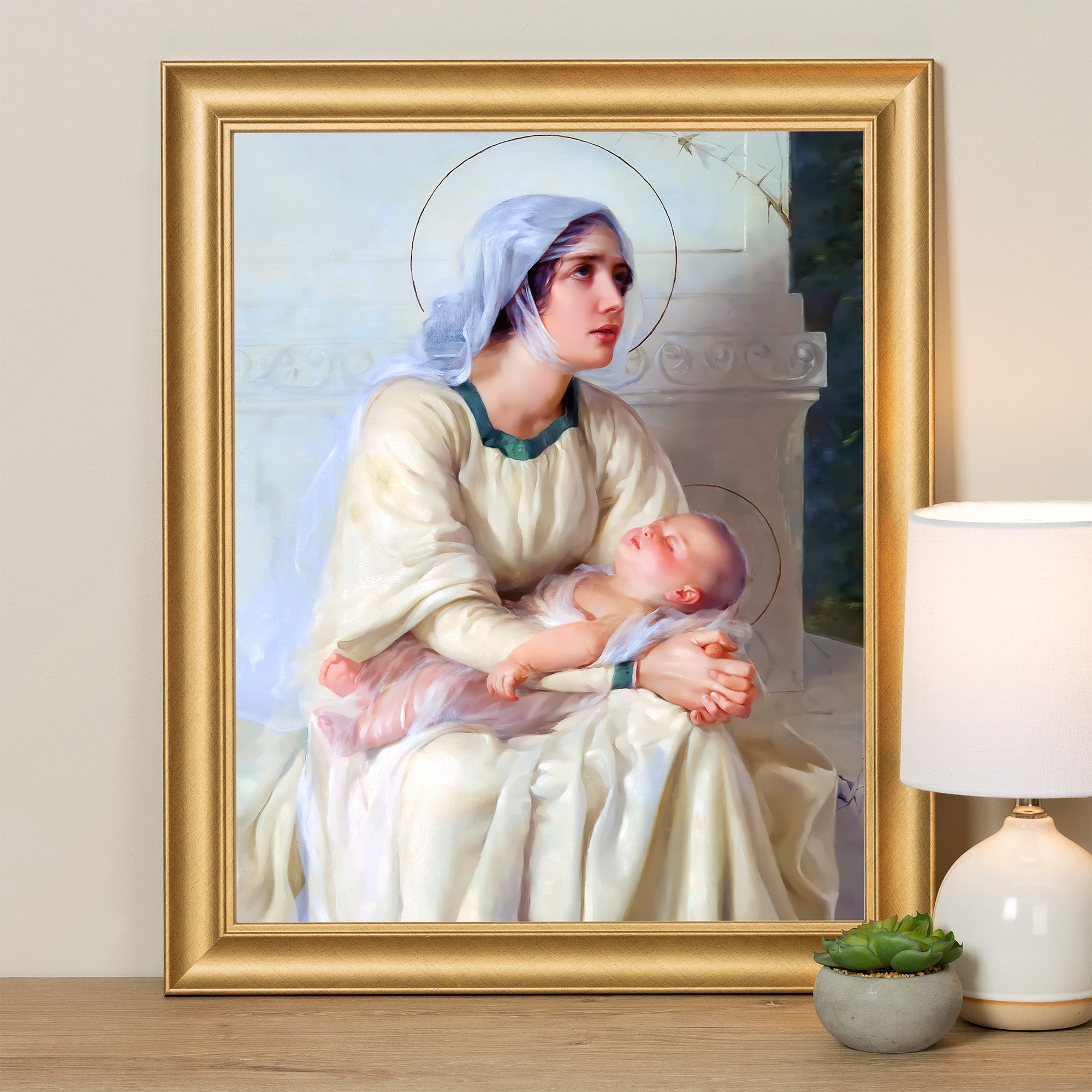 Framed art print of Madonna and child in cream and gold tones, classic style.