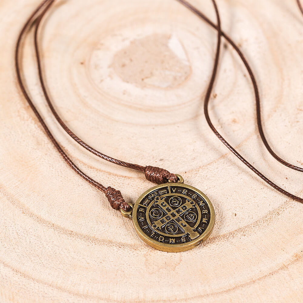 Bronze St. Benedict medallion pendant necklace with a brown cord.