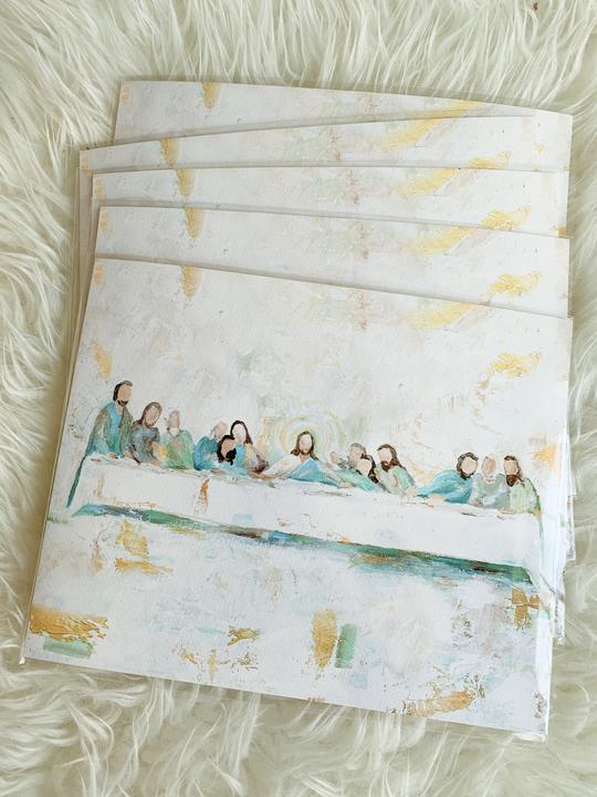 Stack of Last Supper art prints; white with gold accents in impressionist style.