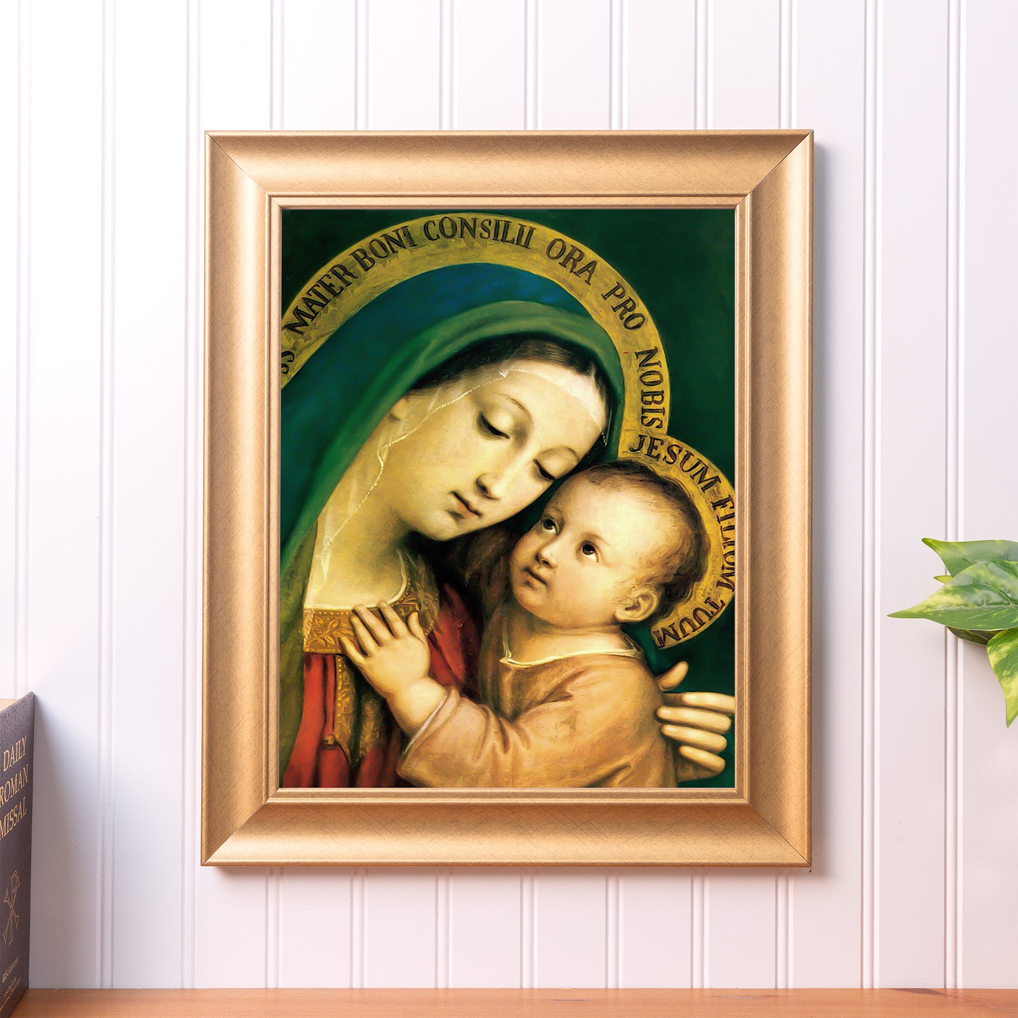 Framed Our Lady of Good Counsel print featuring Mary and child, in green and red, with gold frame.