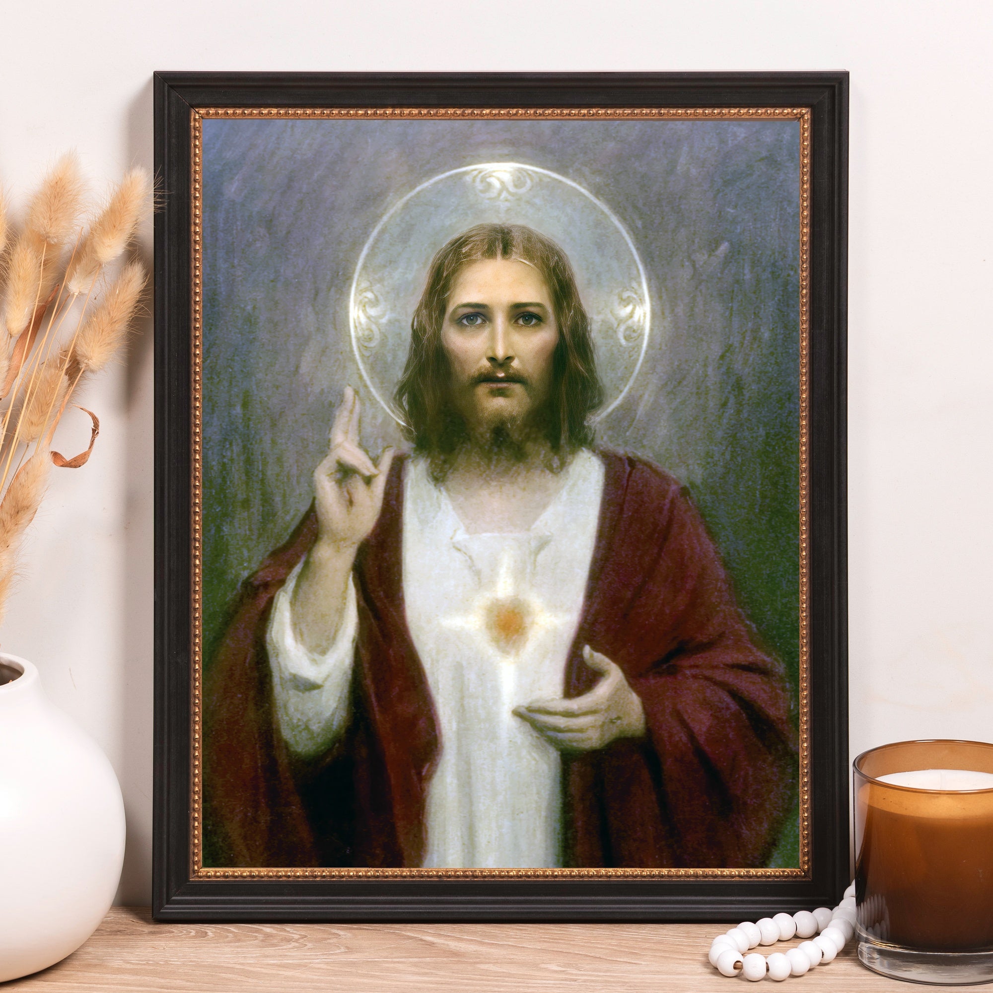 Framed Jesus art print with black frame, gold trim, and religious imagery.