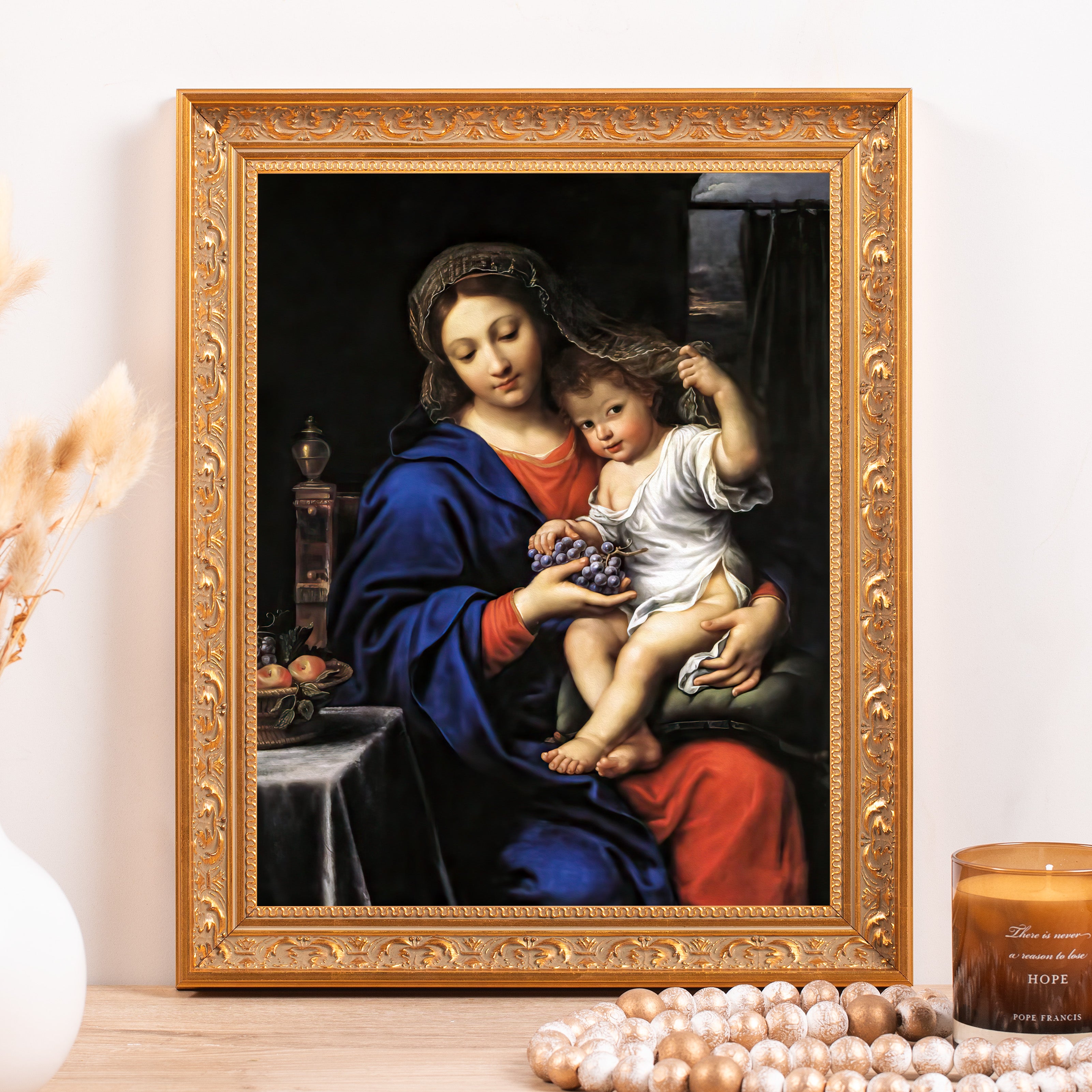 Framed Madonna and Child painting with gold frame, Mary in a blue robe holding grapes.