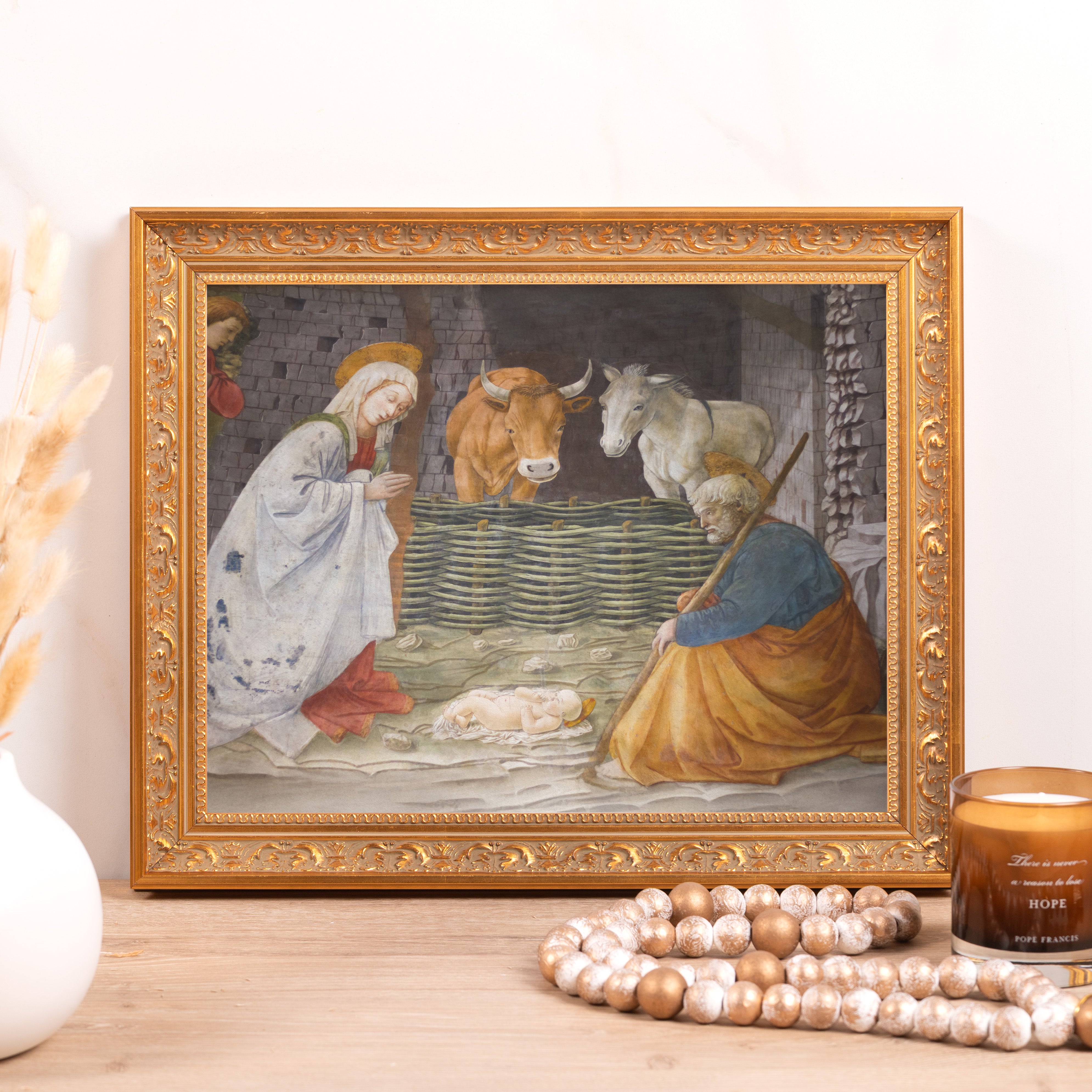 Framed print of the Nativity scene with Mary, Joseph, baby Jesus, and farm animals in gold ornate frame.