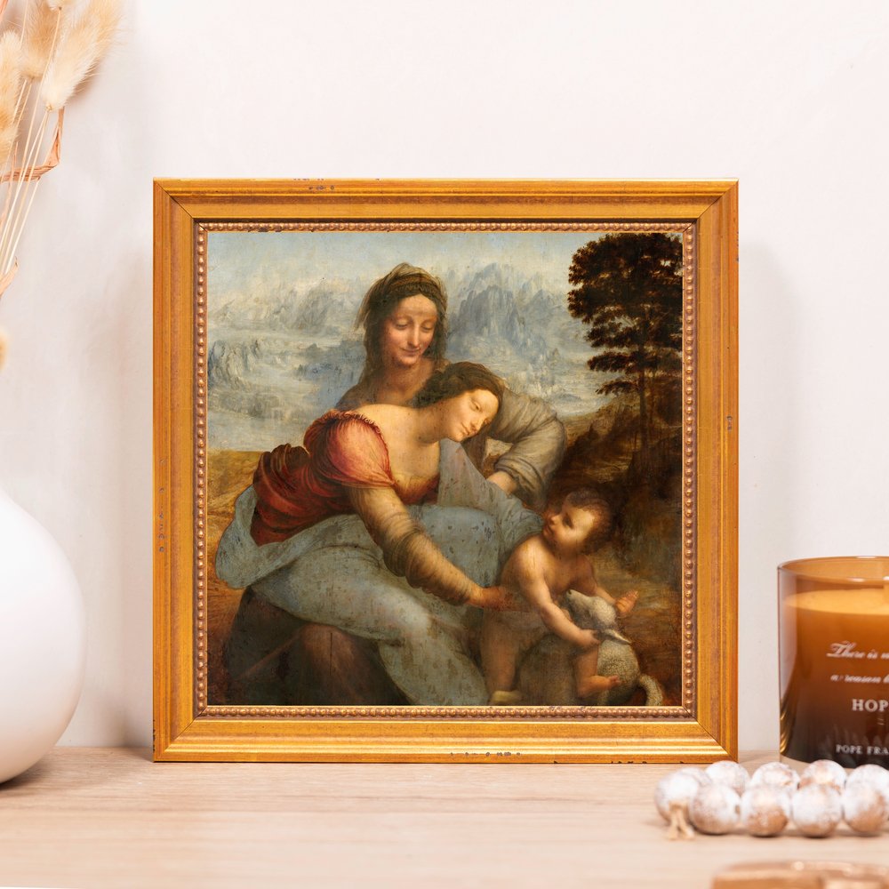 Framed print of "The Virgin and Child with Saint Anne" in an ornate gold frame.