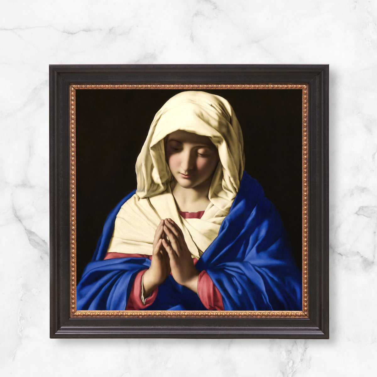 Framed painting of praying Virgin Mary in blue and white.