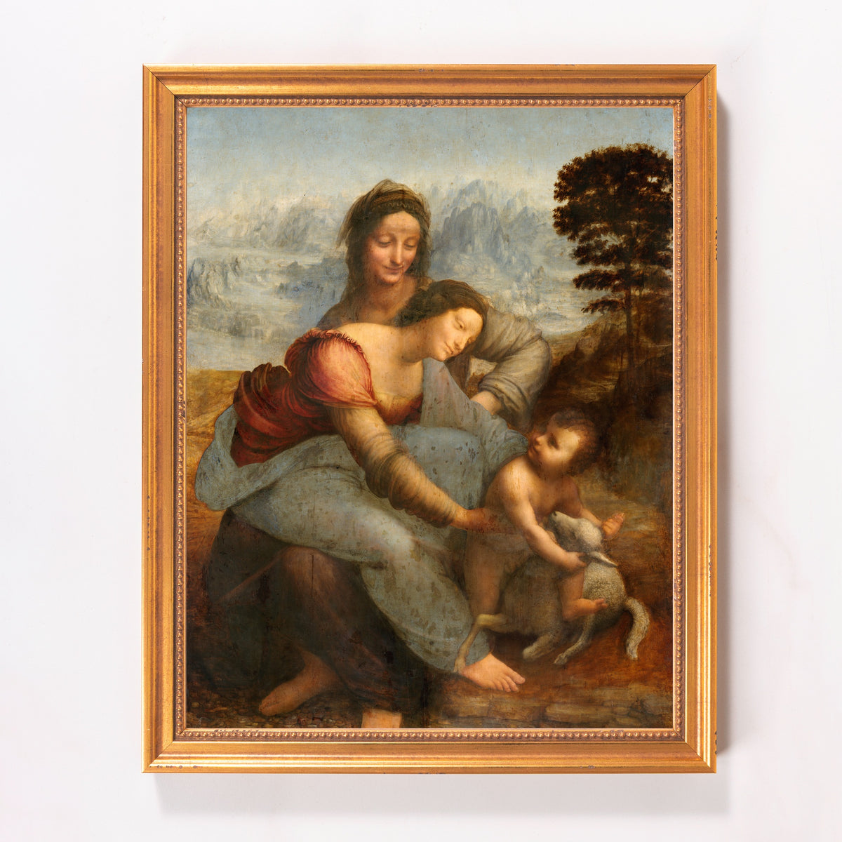 Framed painting of a Madonna with child and St. Anne, painted with muted colors in a classic style.
