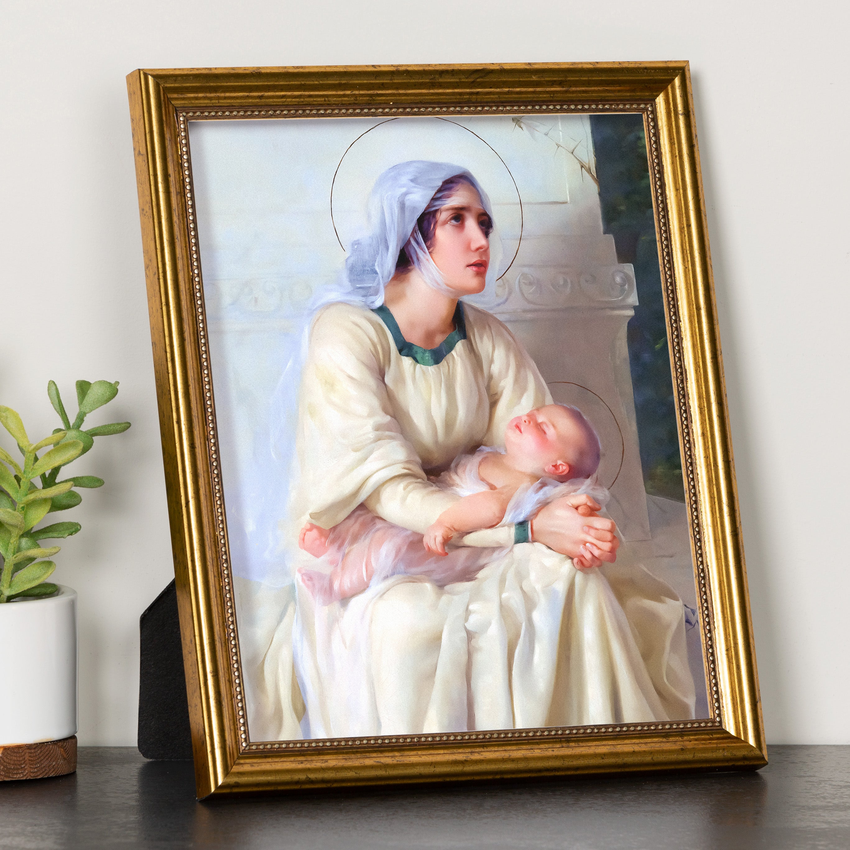 Framed Madonna and Child print with ornate gold frame for home decor or religious use.