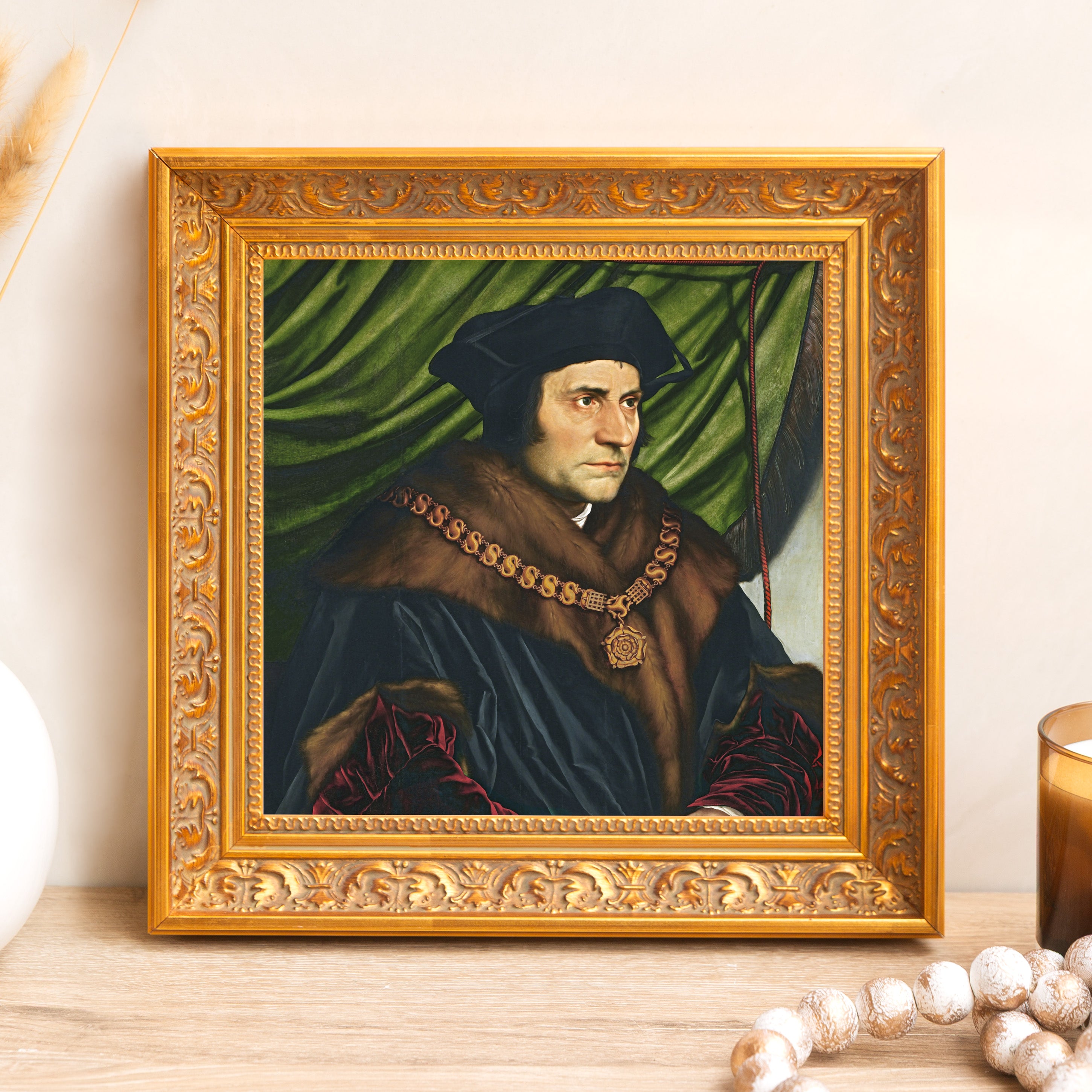 Framed portrait of Thomas More, black robes, fur collar, gold frame, home decor art piece.