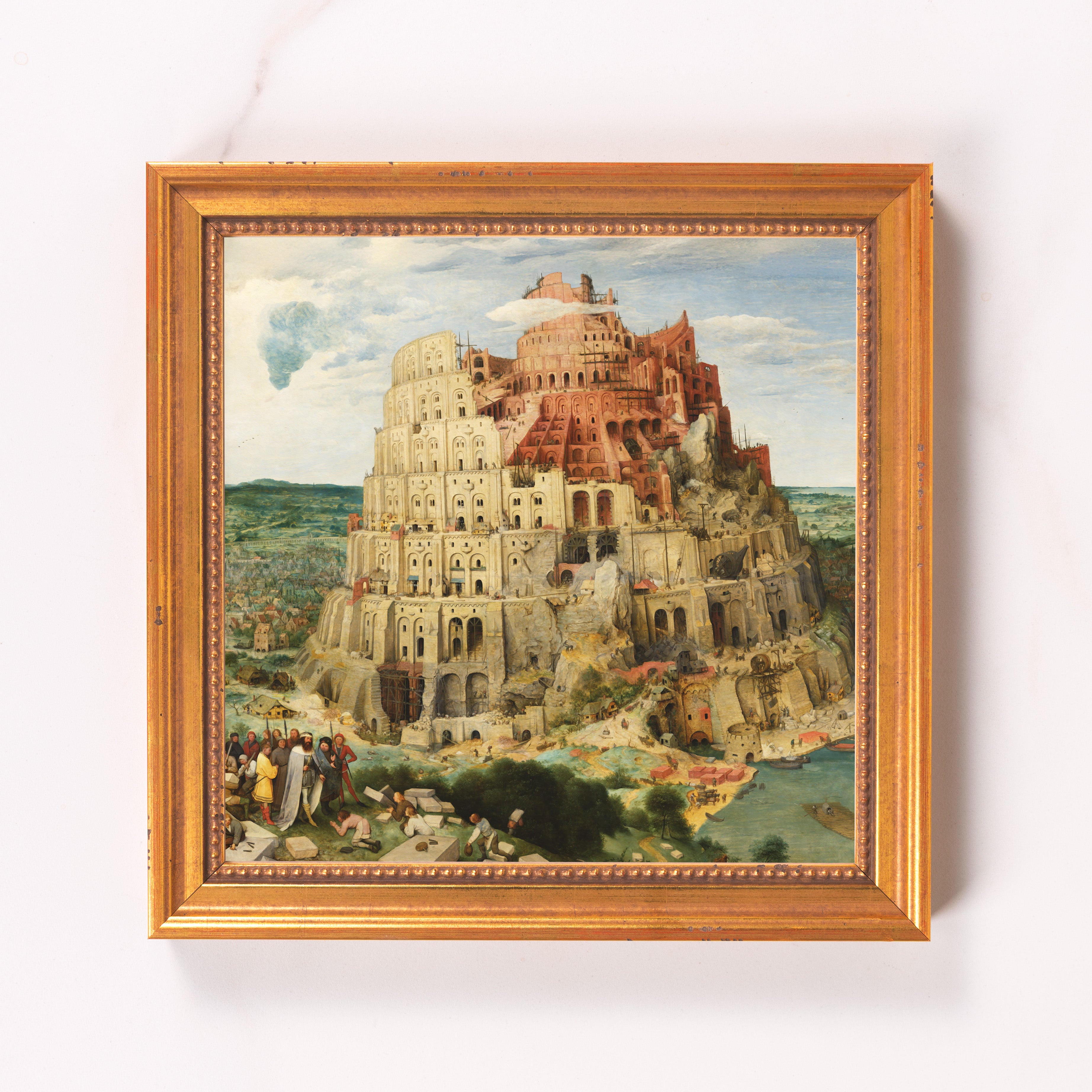 Framed Tower of Babel print; painting depicting an unfinished tower in cream, red, and brown tones.