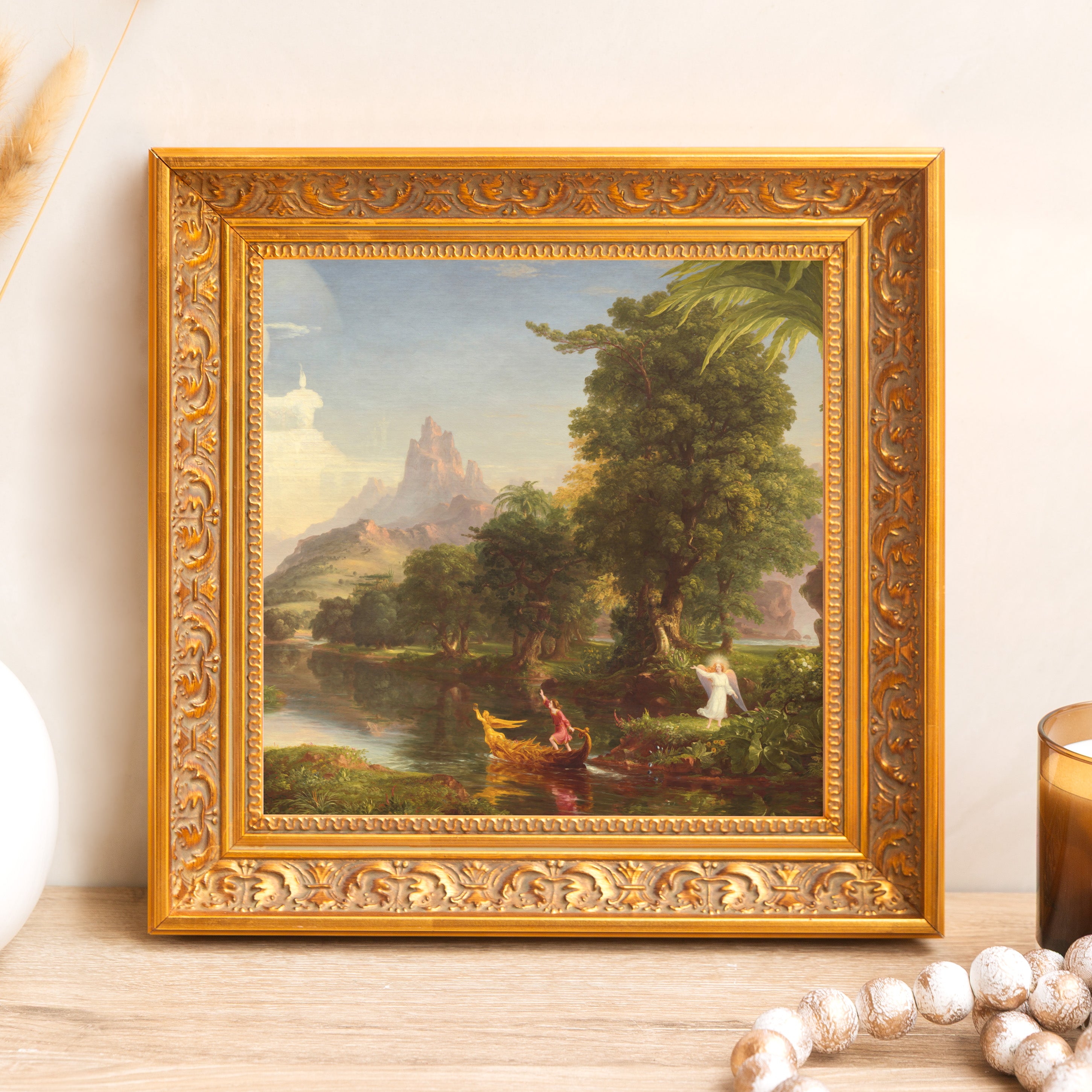 Framed painting, river landscape with figures, gold-toned ornate frame.