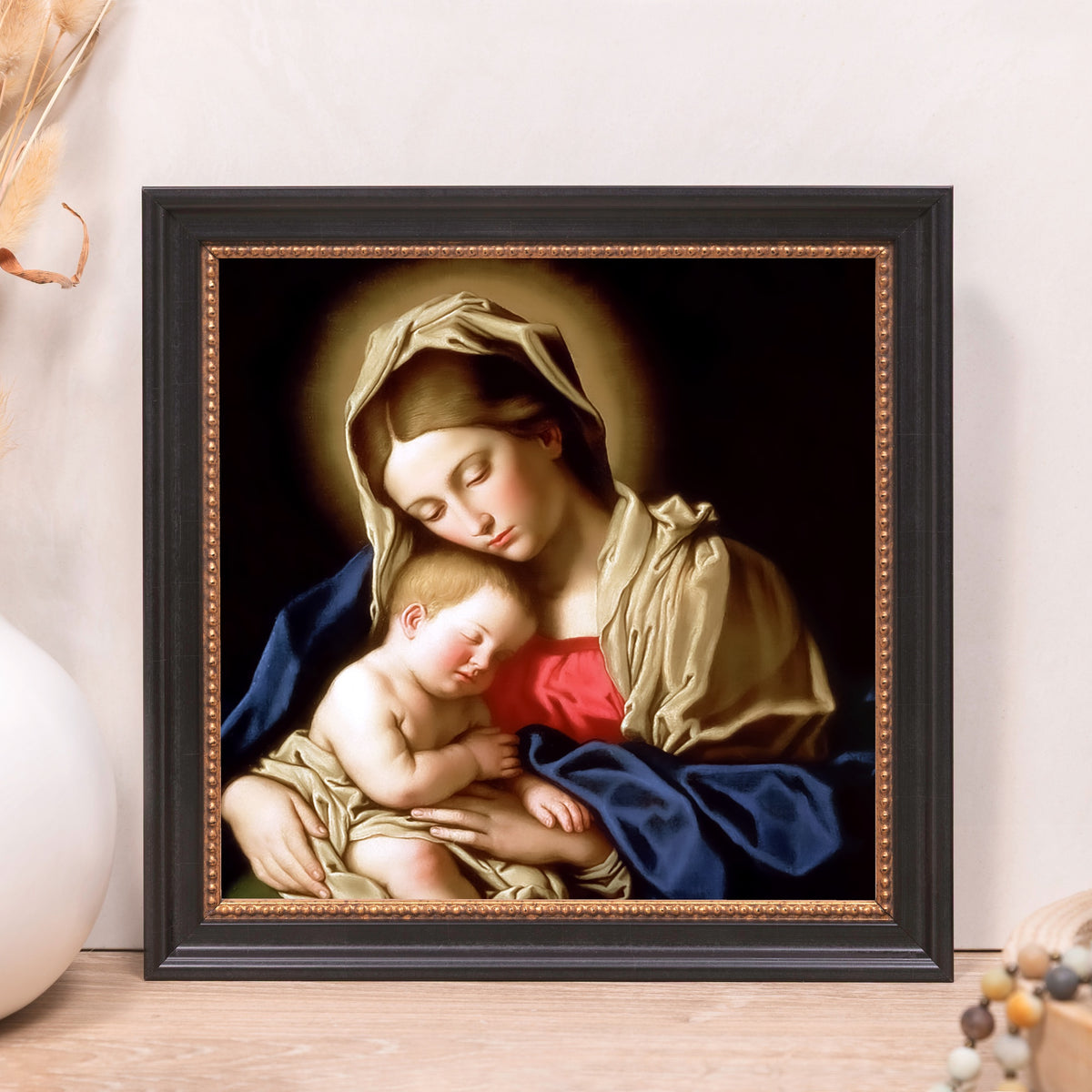 Framed Madonna and Child print; oil painting style with black frame and gold accents.