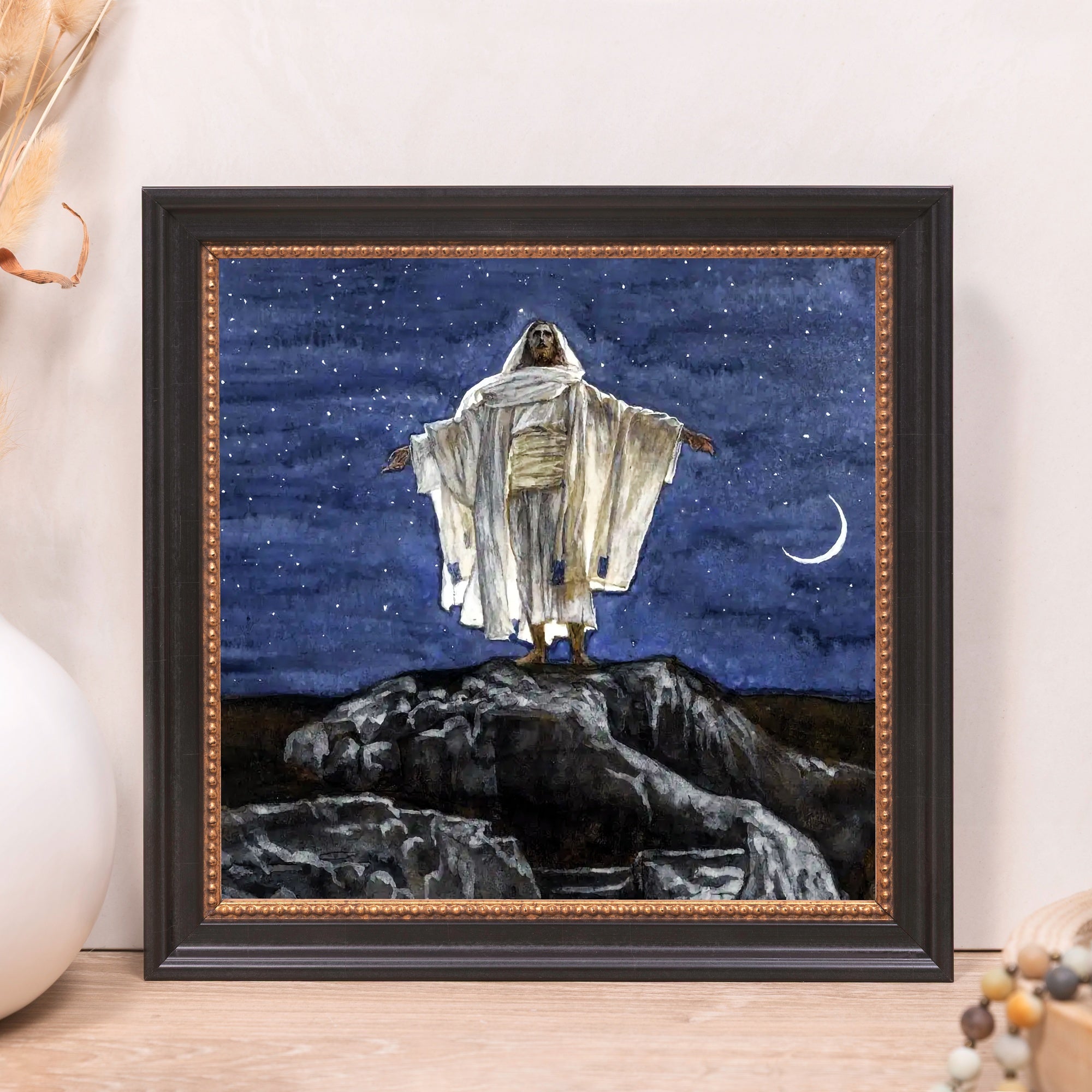 Framed artwork of Jesus Christ on a mountain under a night sky with stars and a crescent moon.